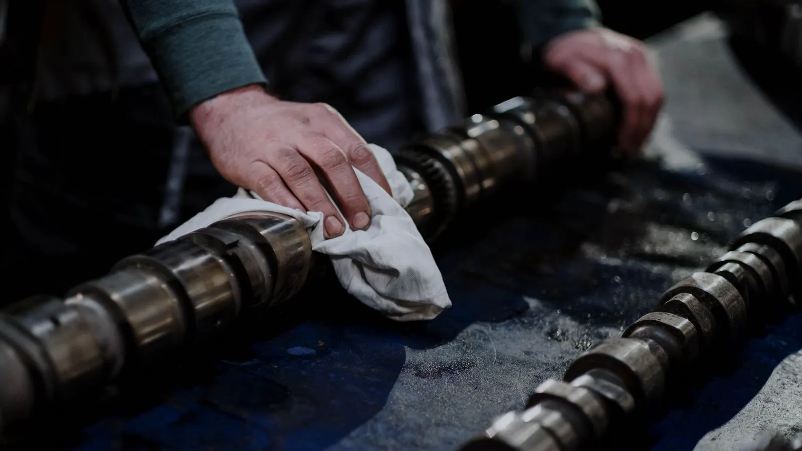Technician holding a grease gun near a bearing housing