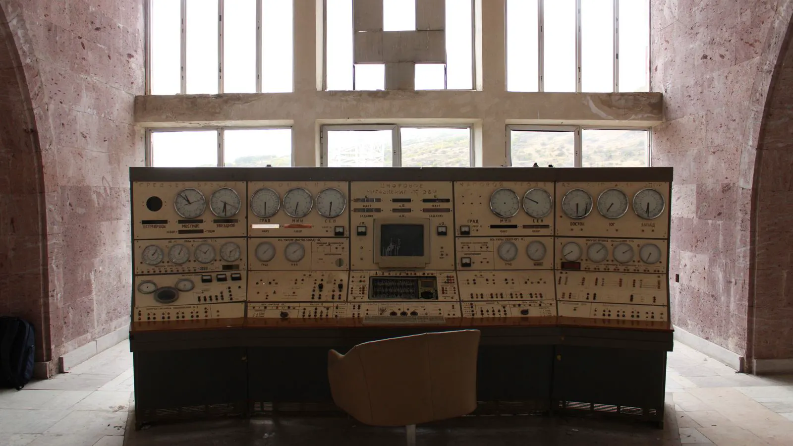 A metal control panel displaying pressure gauges and digital readouts