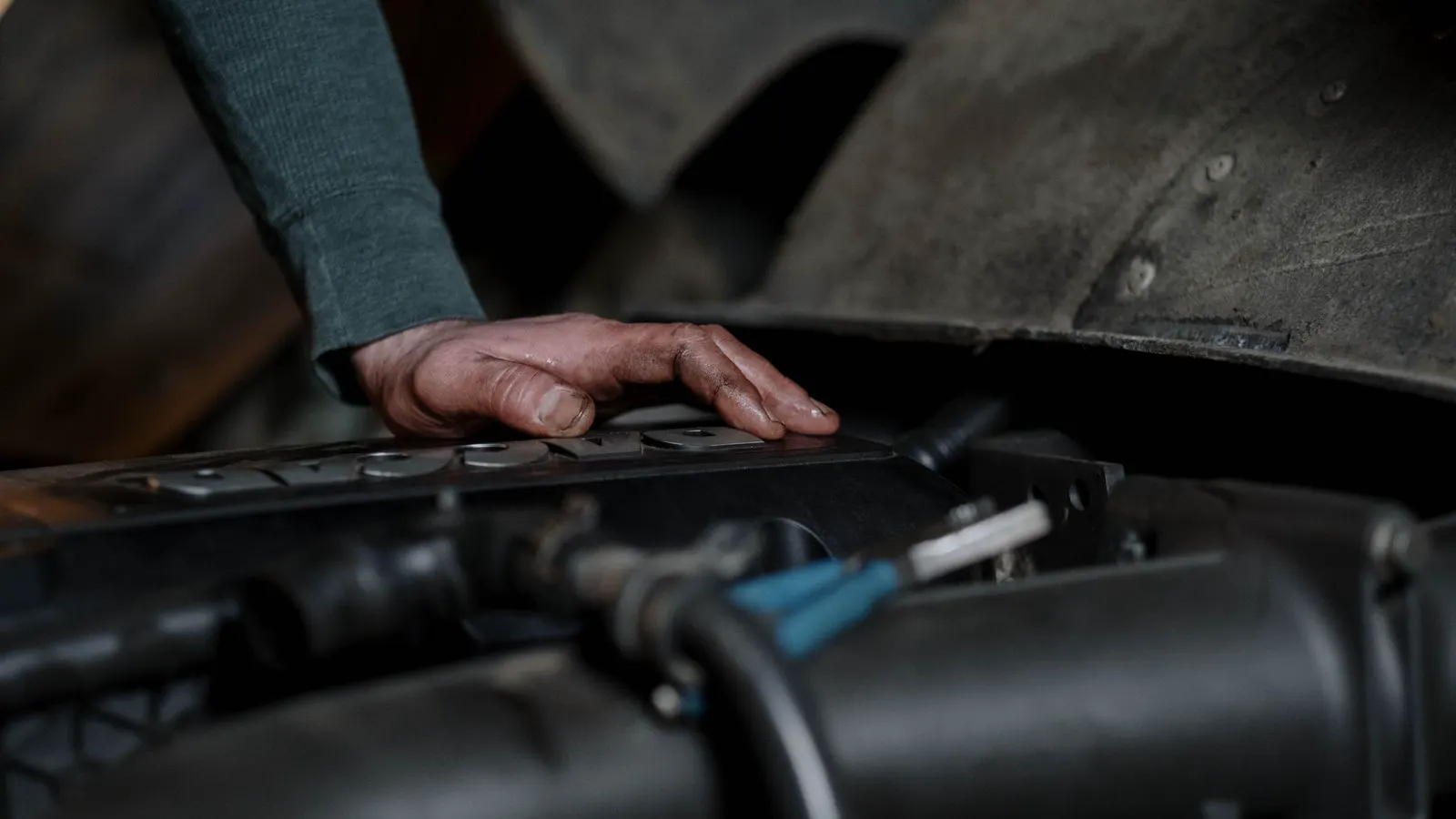 A technician inspecting a pneumatic cylinder during maintenance