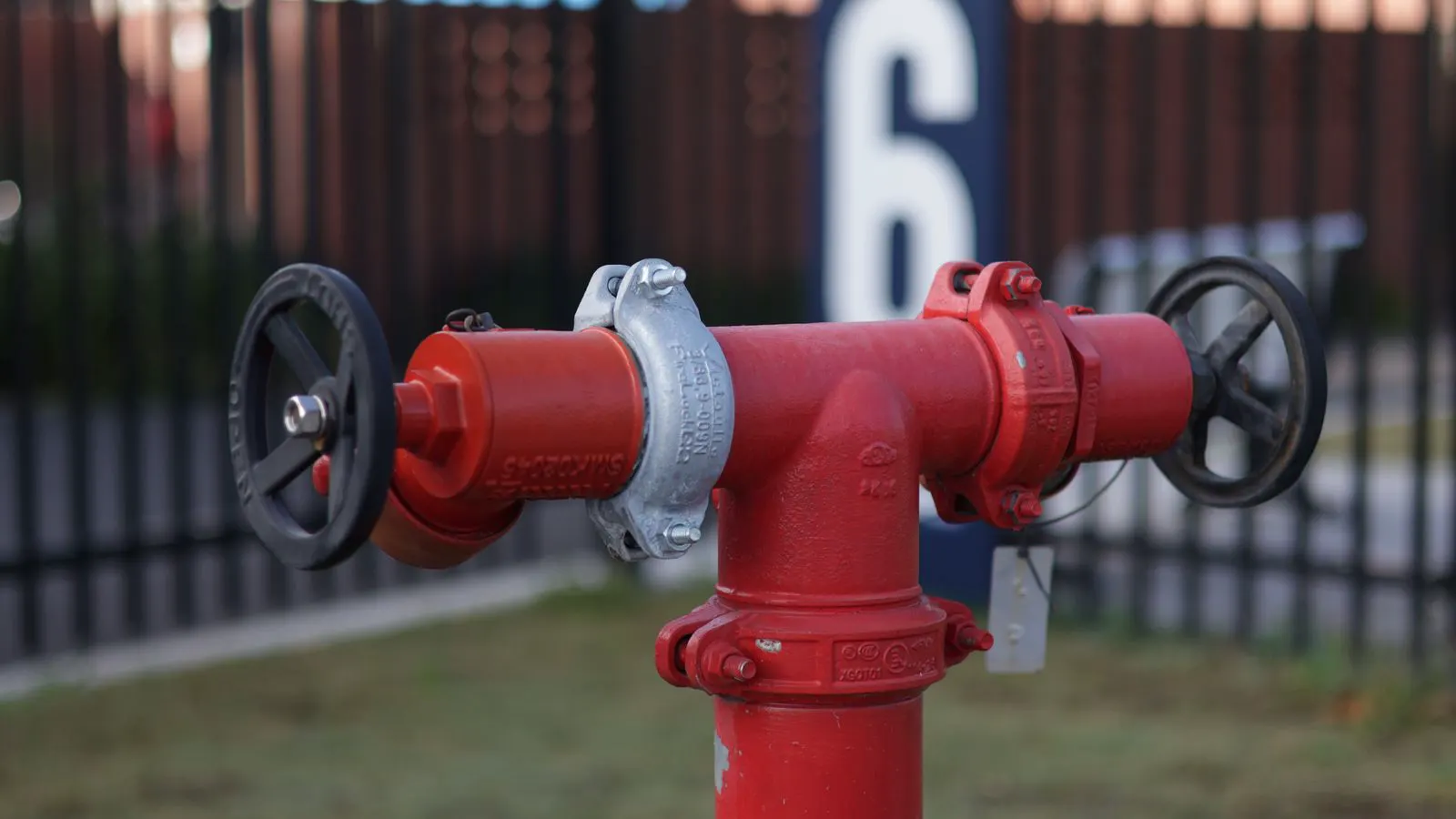 Technician using a wrench to inspect a butterfly valve actuator.