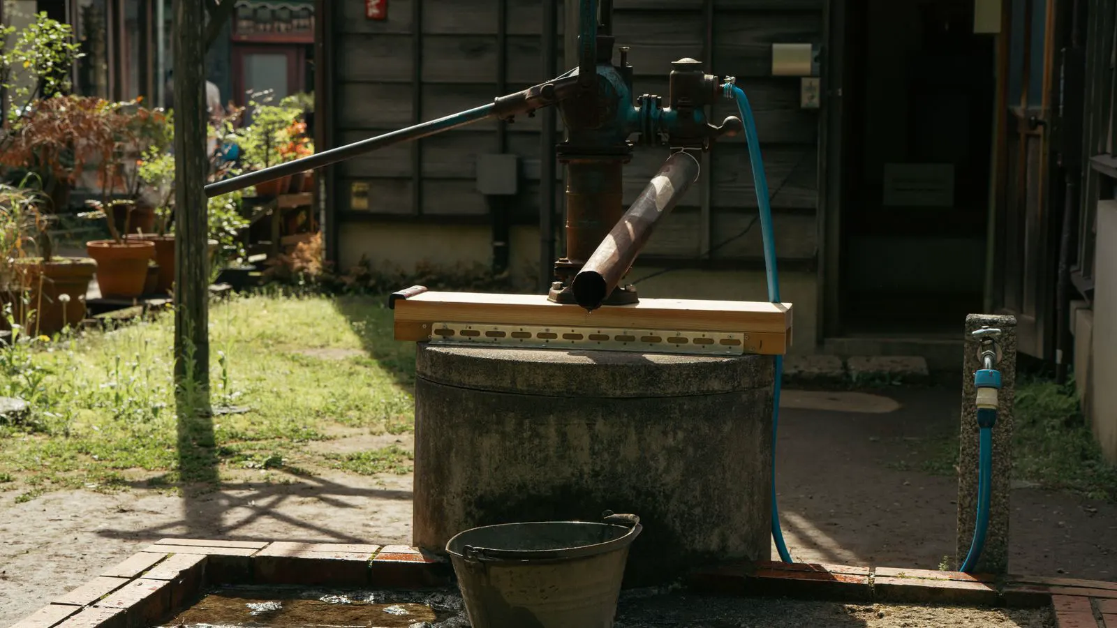 A stainless steel centrifugal pump mounted on a concrete base