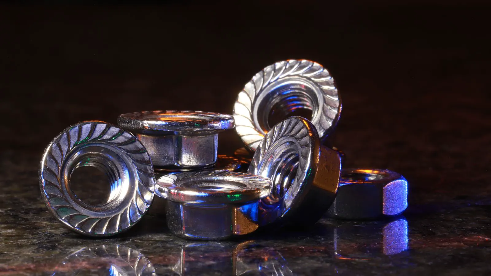 A metal tray holding a sorted group of hex bolts