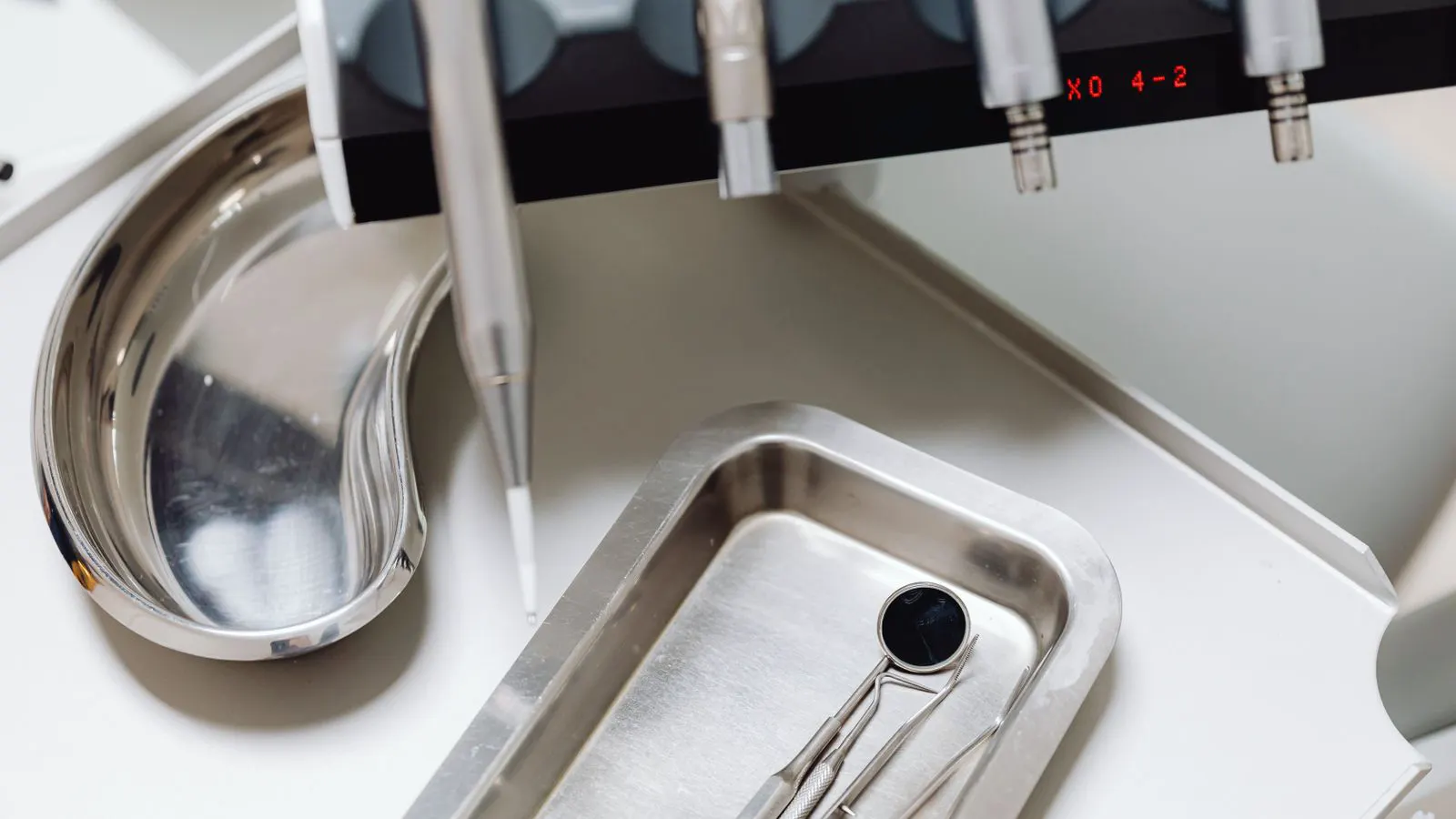 A tray of stainless steel washers arranged neatly on a workbench