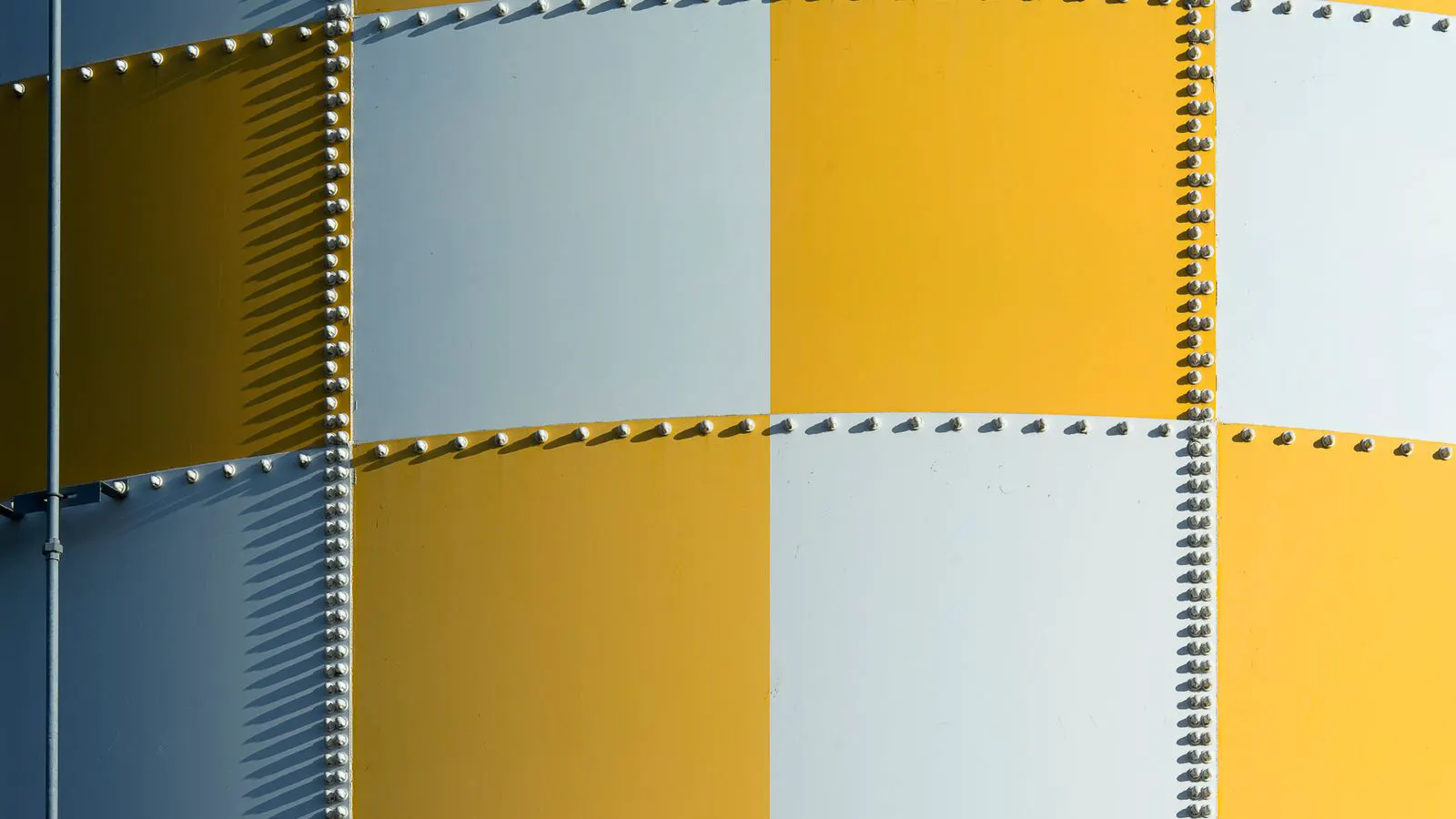 Pile of small stainless steel rivets on a metal tray