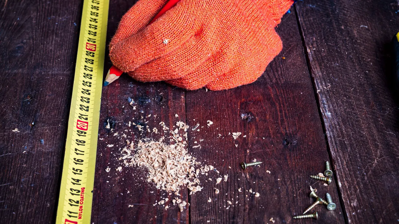 Technician using a coating thickness gauge on a galvanized bolt
