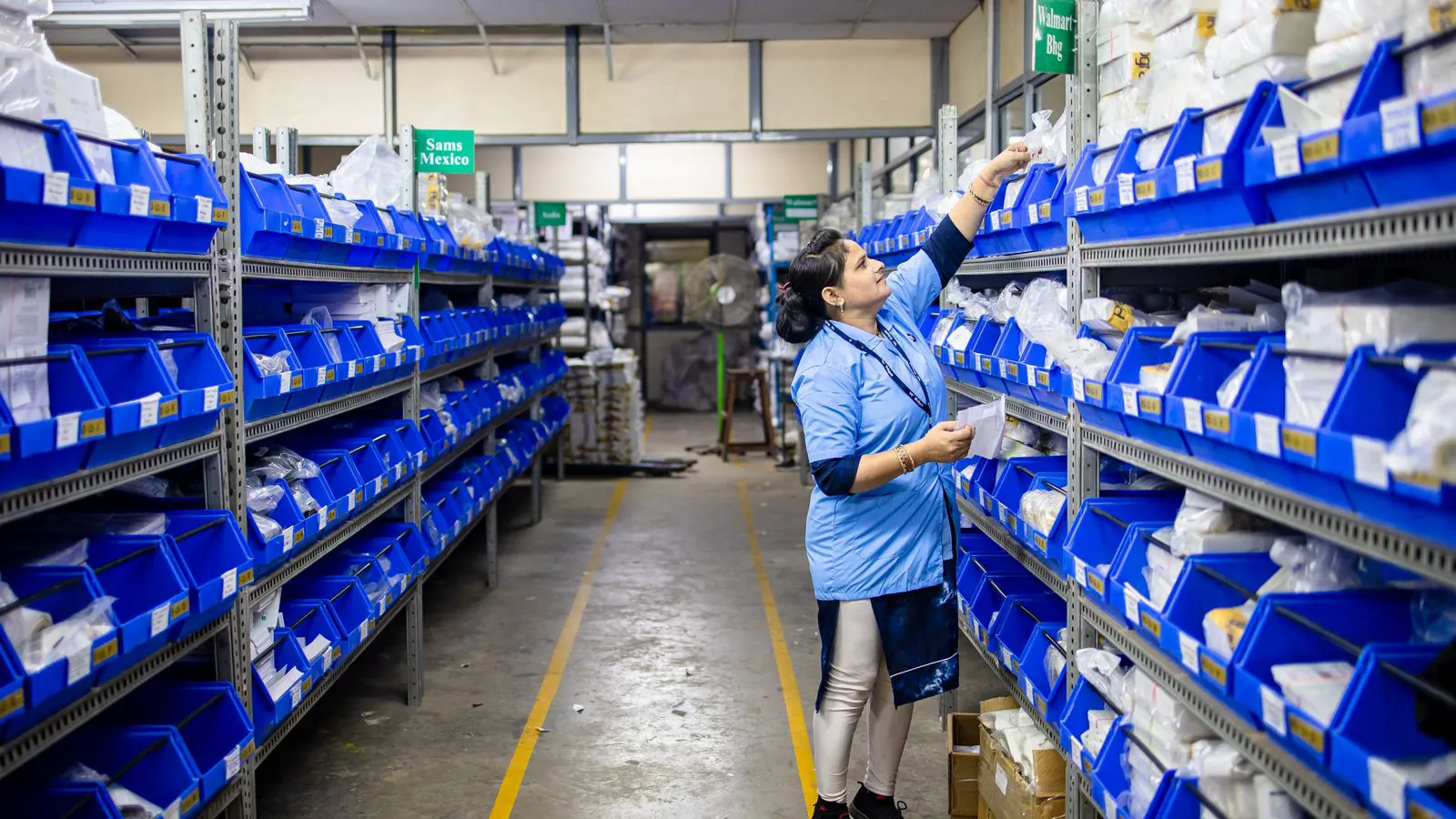 A warehouse aisle displaying organized bins of industrial fasteners