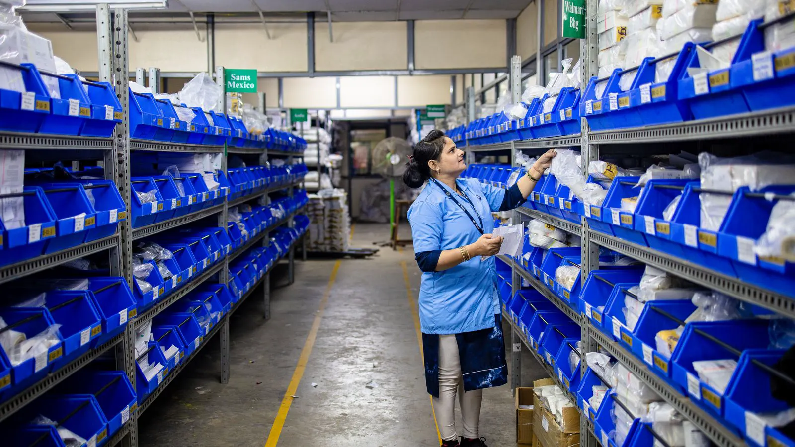 Industrial warehouse racks holding organized steel fastener bins