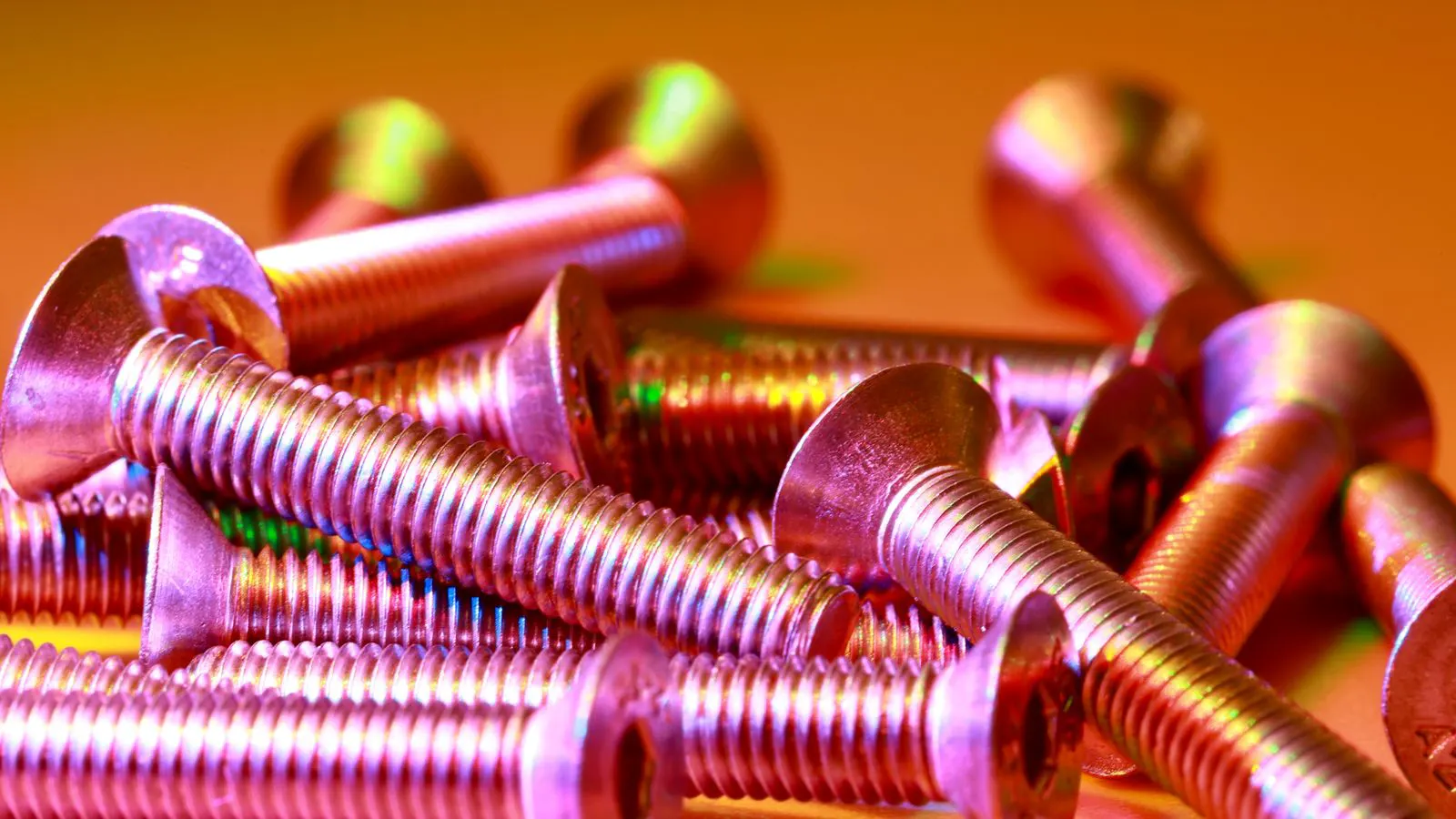 Steel bolts resting on a metal workbench