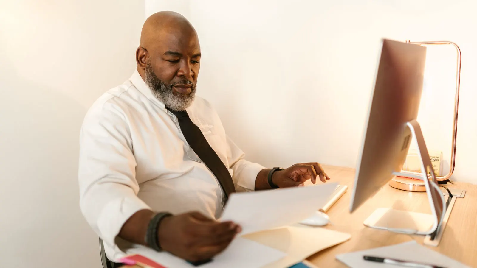 A professional reviewing fastener order documents at a desk