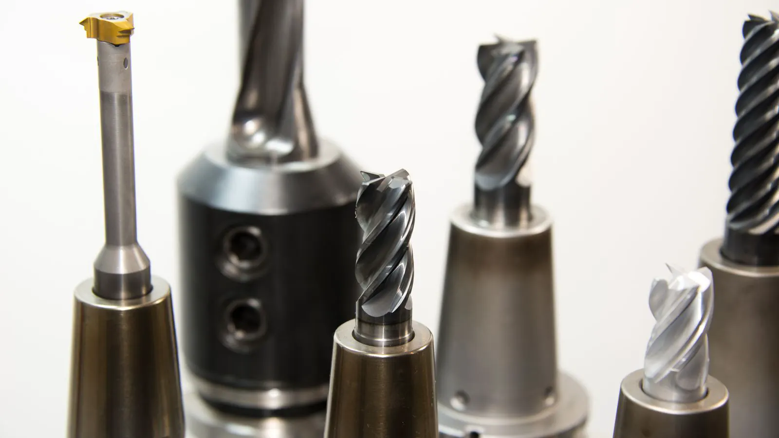 Two types of hex bolts lying on a metal workbench
