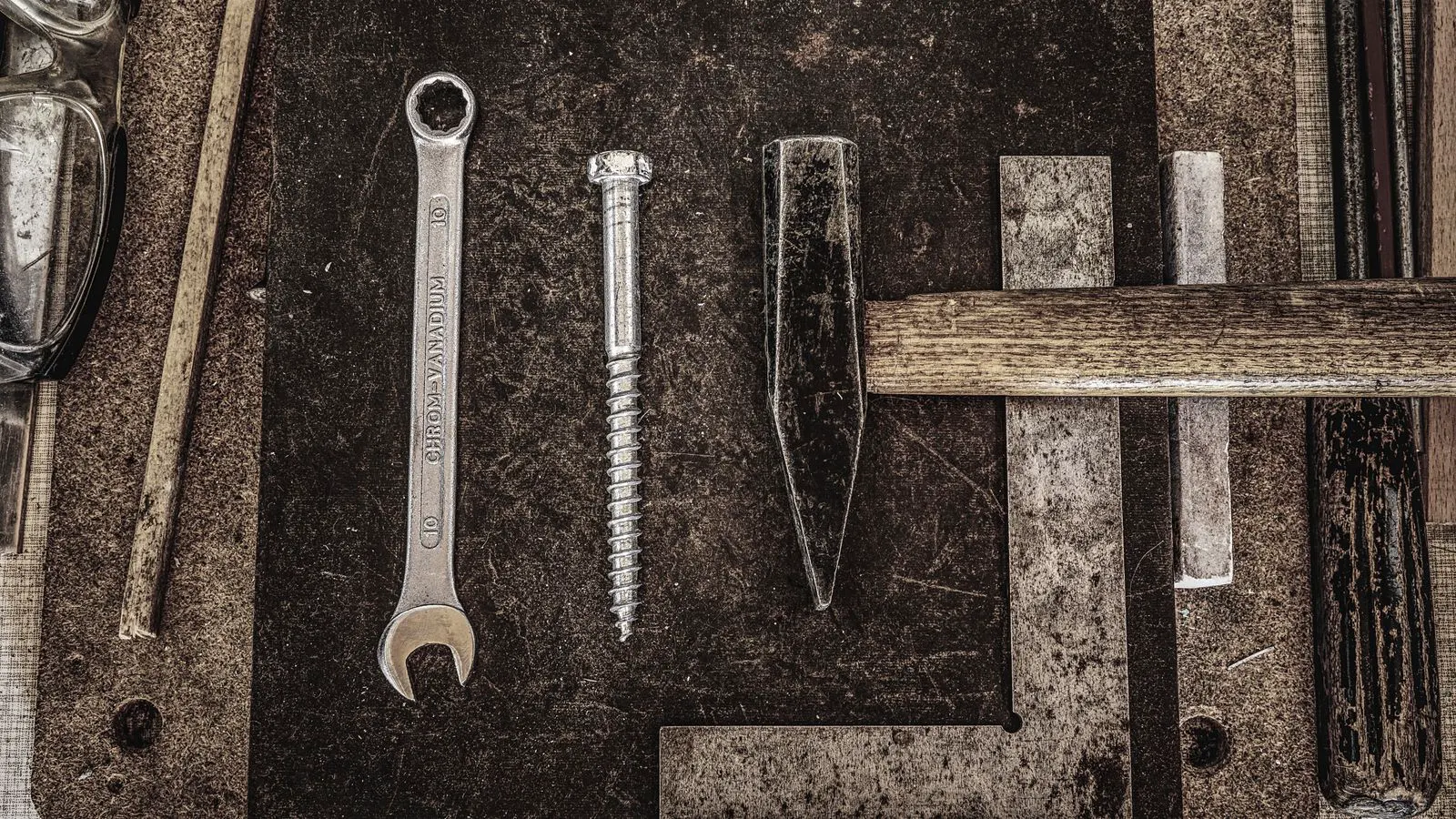 A close up of a flange washer under a hex bolt head on a steel plate.