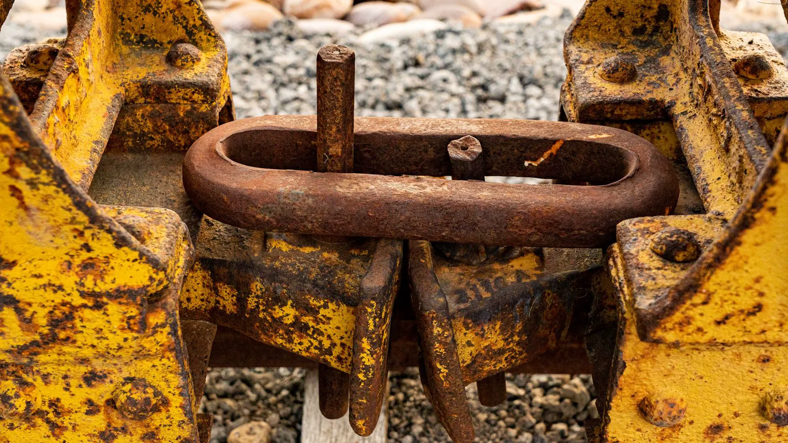 close view of a corroded fastener joint with inspection tools nearby