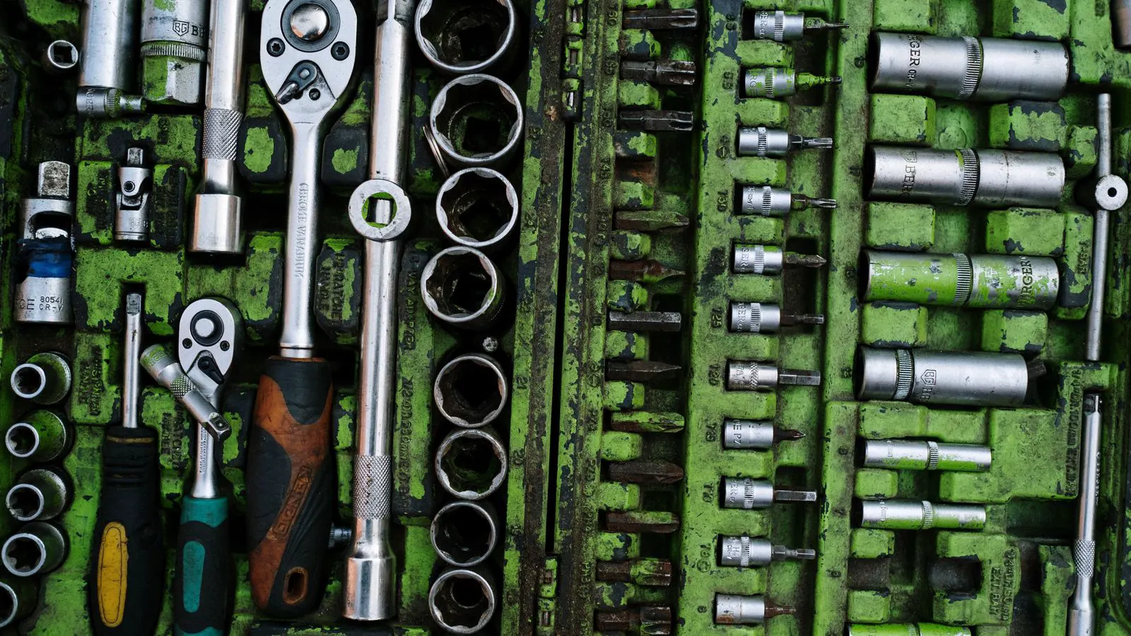 Close up of a hex bolt head showing stamped letters and numbers.