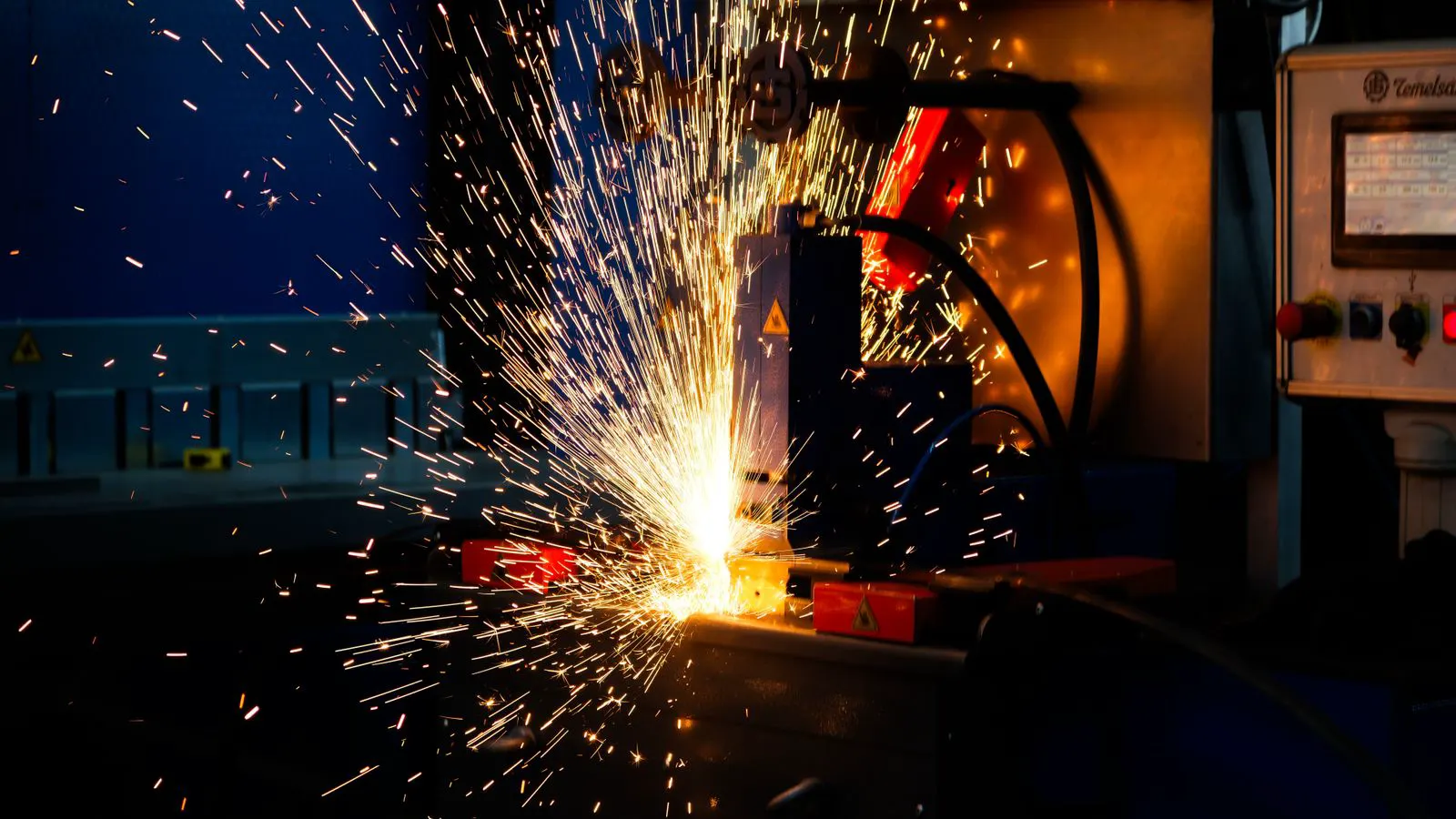 Professional industrial MIG welding equipment in a metal fabrication shop