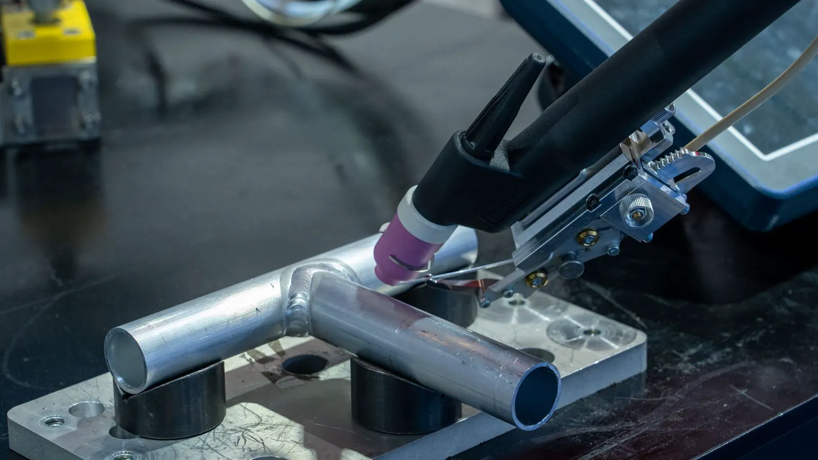 Close up of an industrial wire feeder housing with control panel
