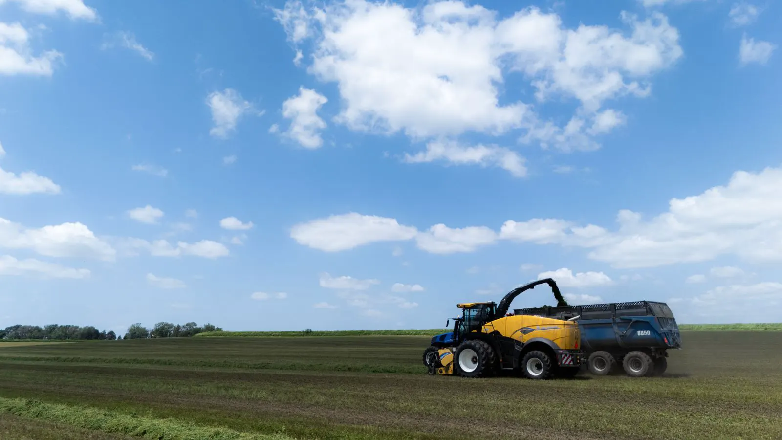 Technician inspecting hydraulic lines on a farm tractor