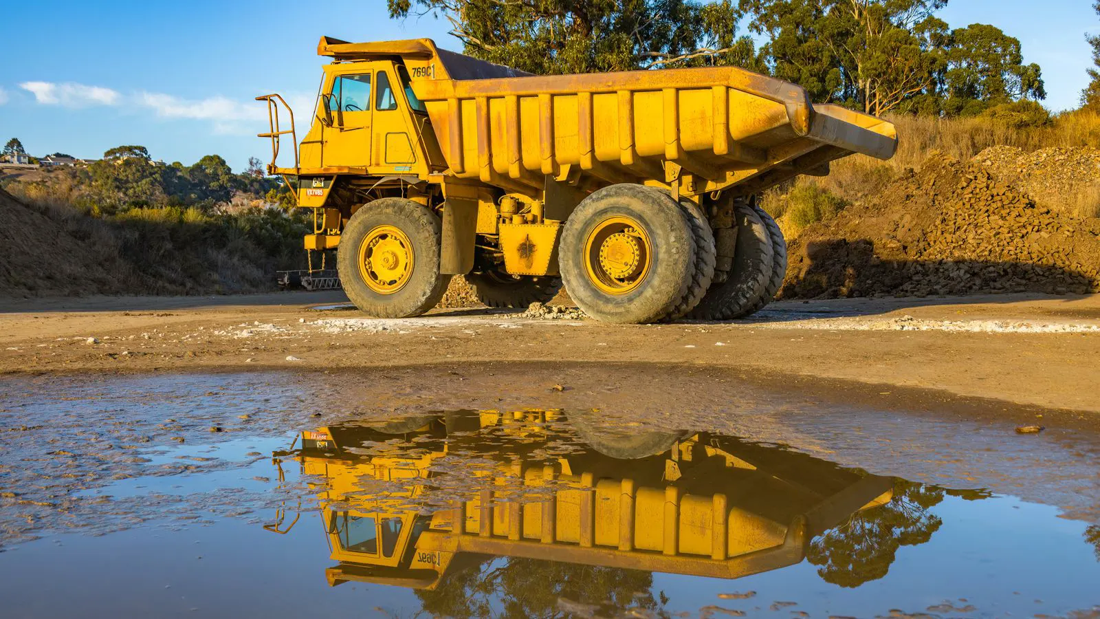 Engineer inspecting a used mining crusher at a yard