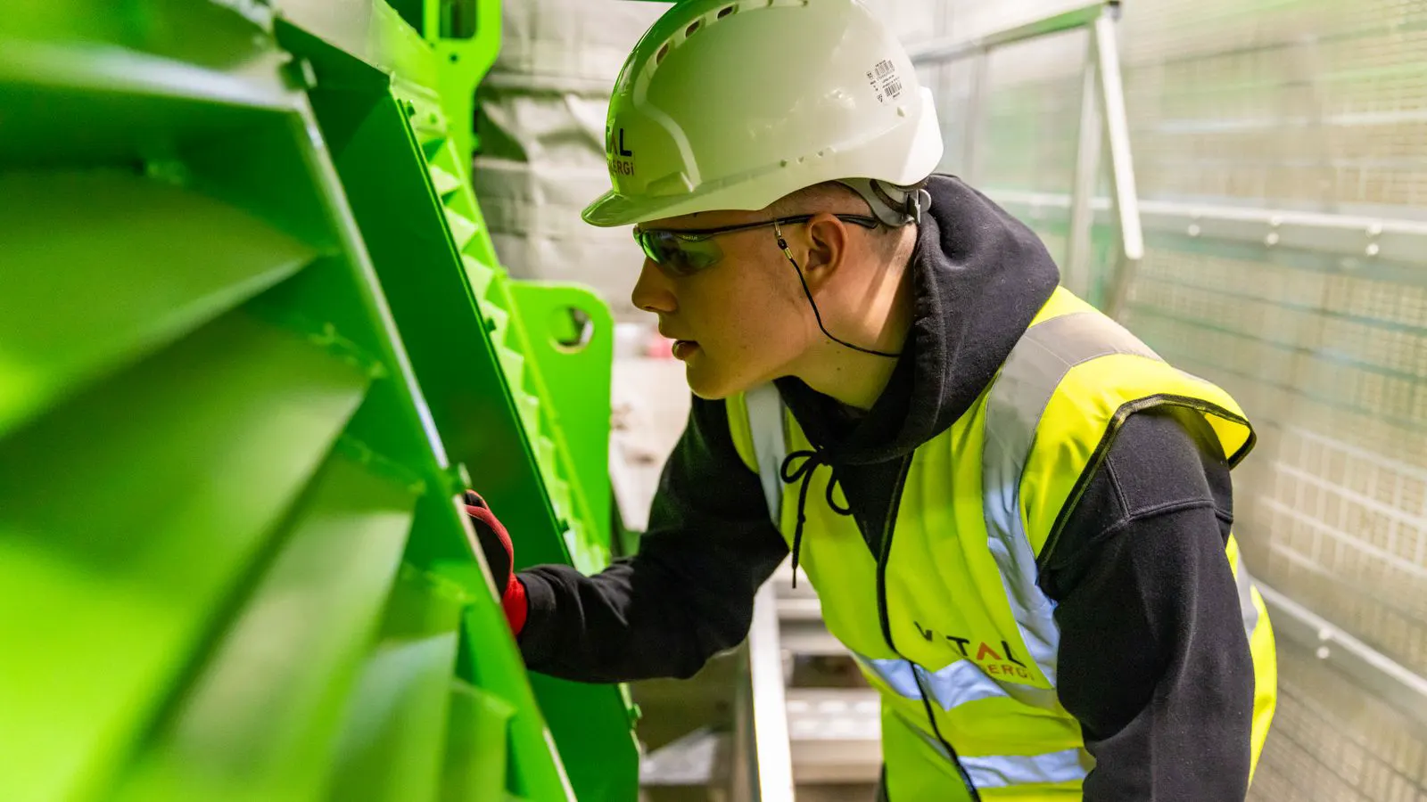 Engineer checks guard interlock on mining equipment before startup