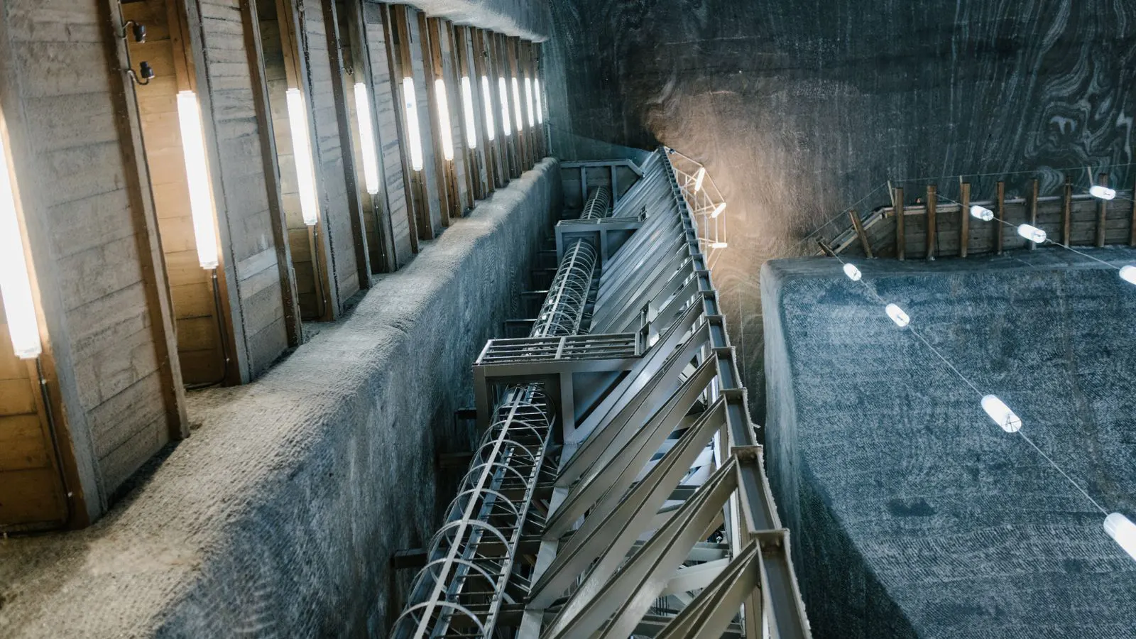 Ventilation ducts and air flow controls in a deep underground shaft.