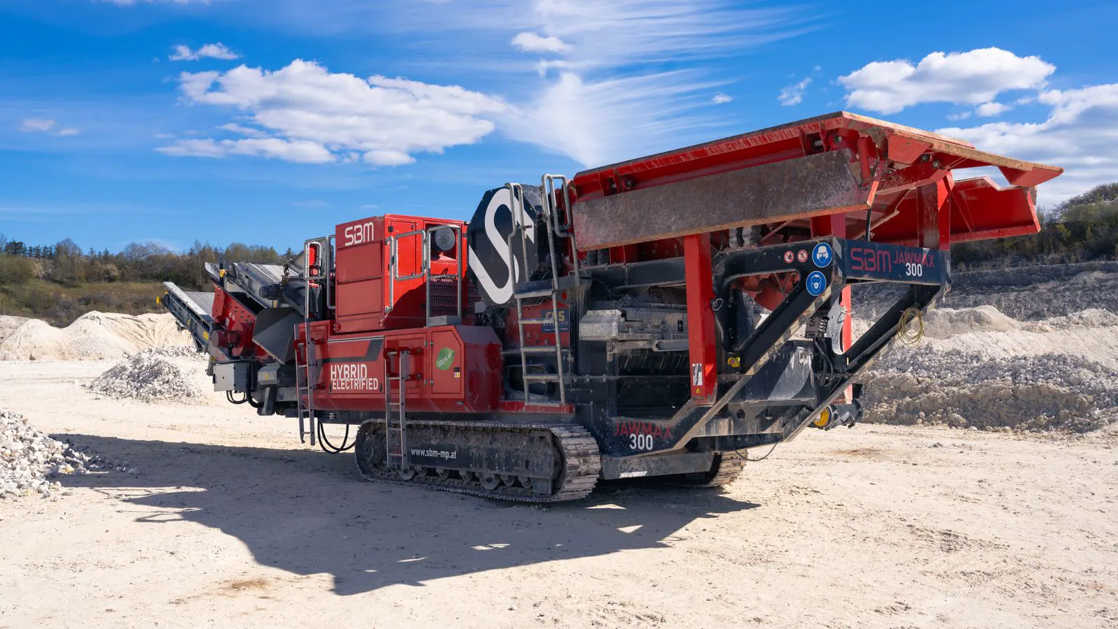 A large industrial crusher processing hard rock material in a mine.
