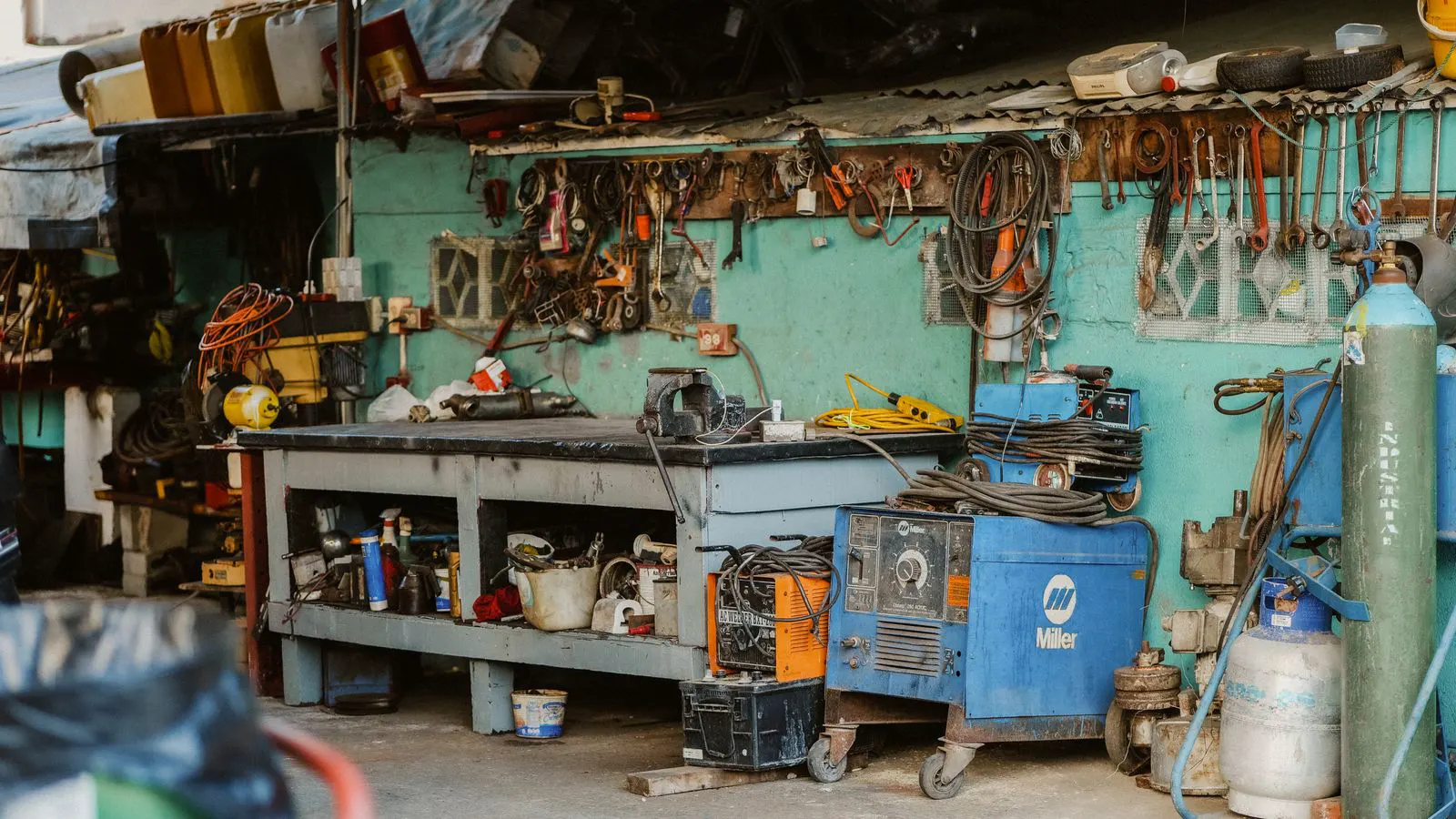 Maintenance crew inspecting hydraulic components in a mining facility