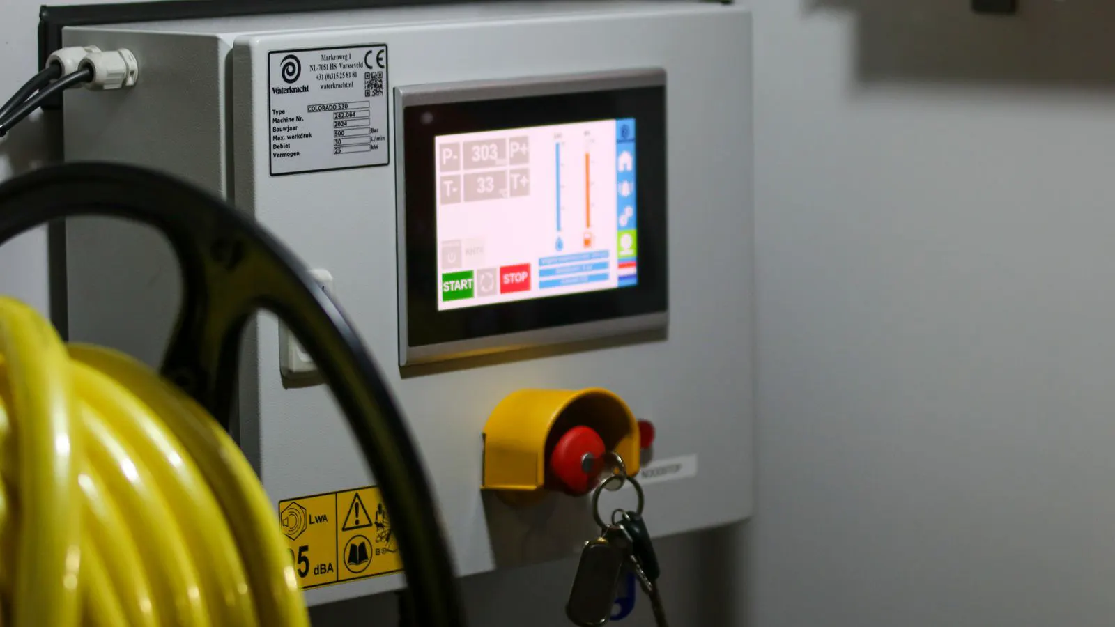 A metal safety guard installed on a heavy industrial machine frame.