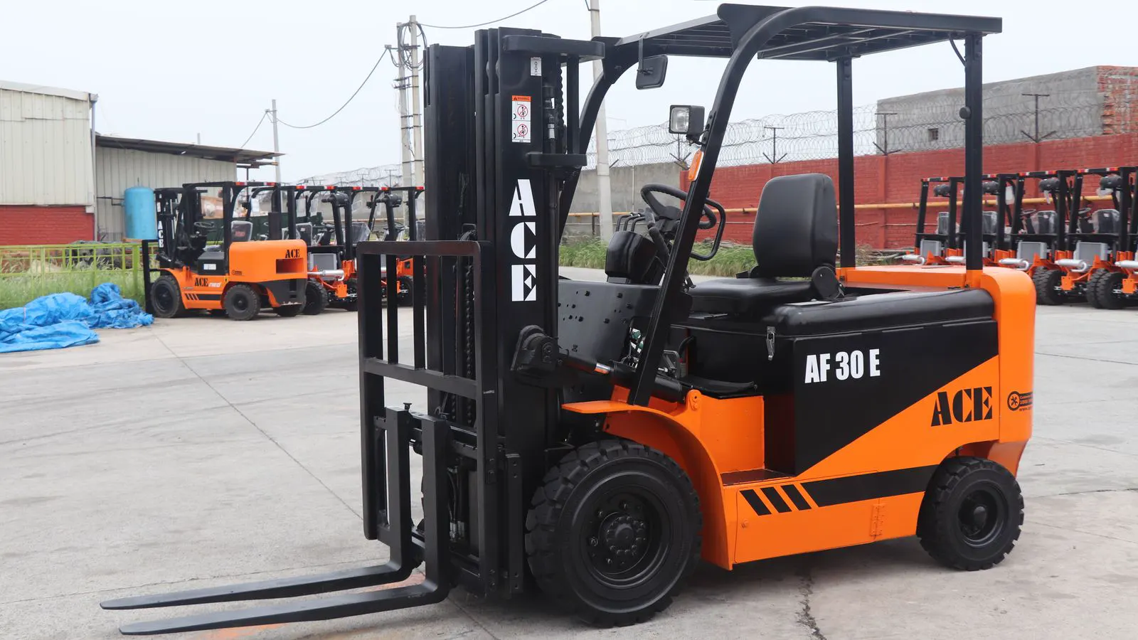An electric reach truck parked inside a modern distribution center.
