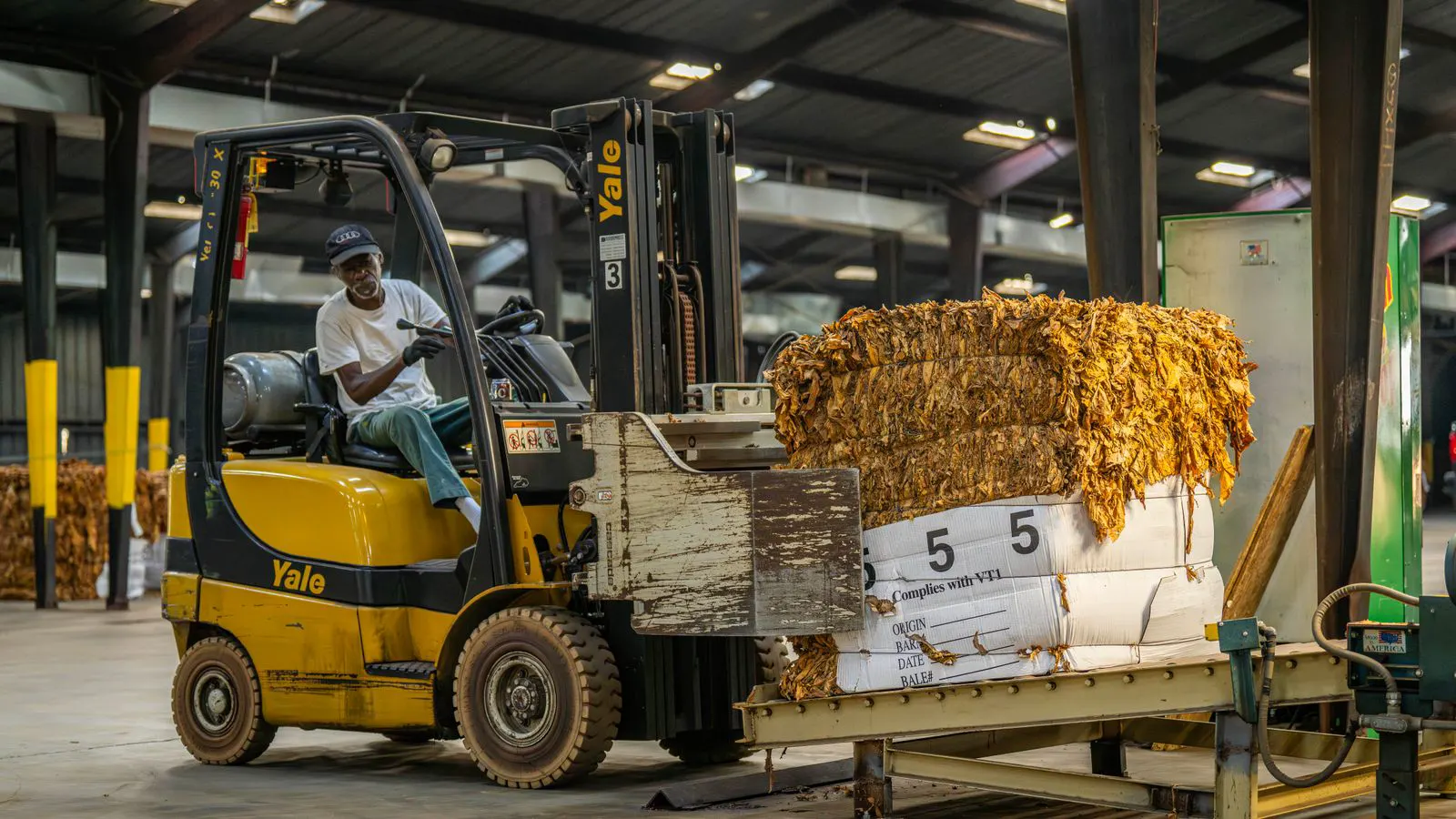 An electric forklift parked in a warehouse aisle