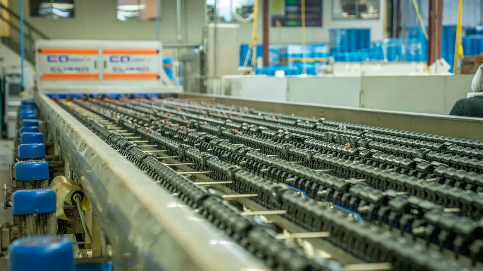 A long rubber belt carrying material on steel rollers