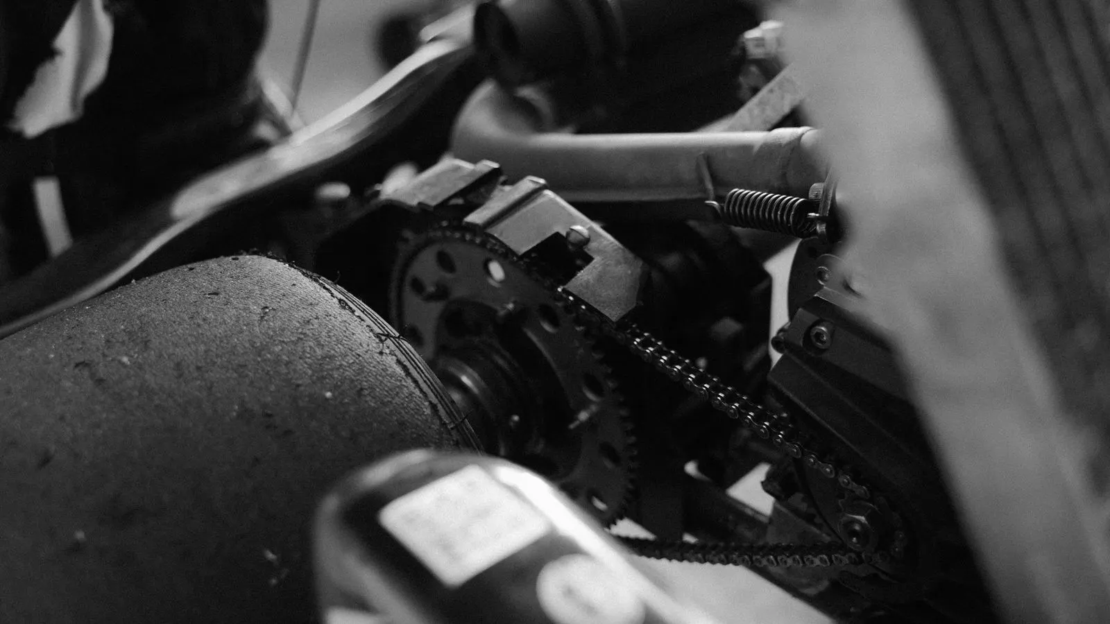 Close up of an electric hoist motor and chain assembly