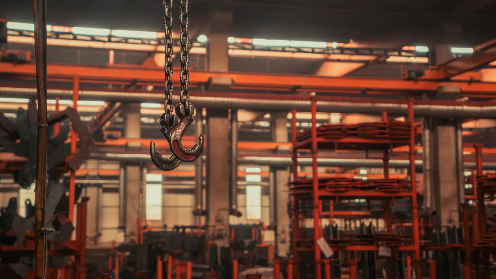Steel overhead crane beams suspended above a warehouse floor