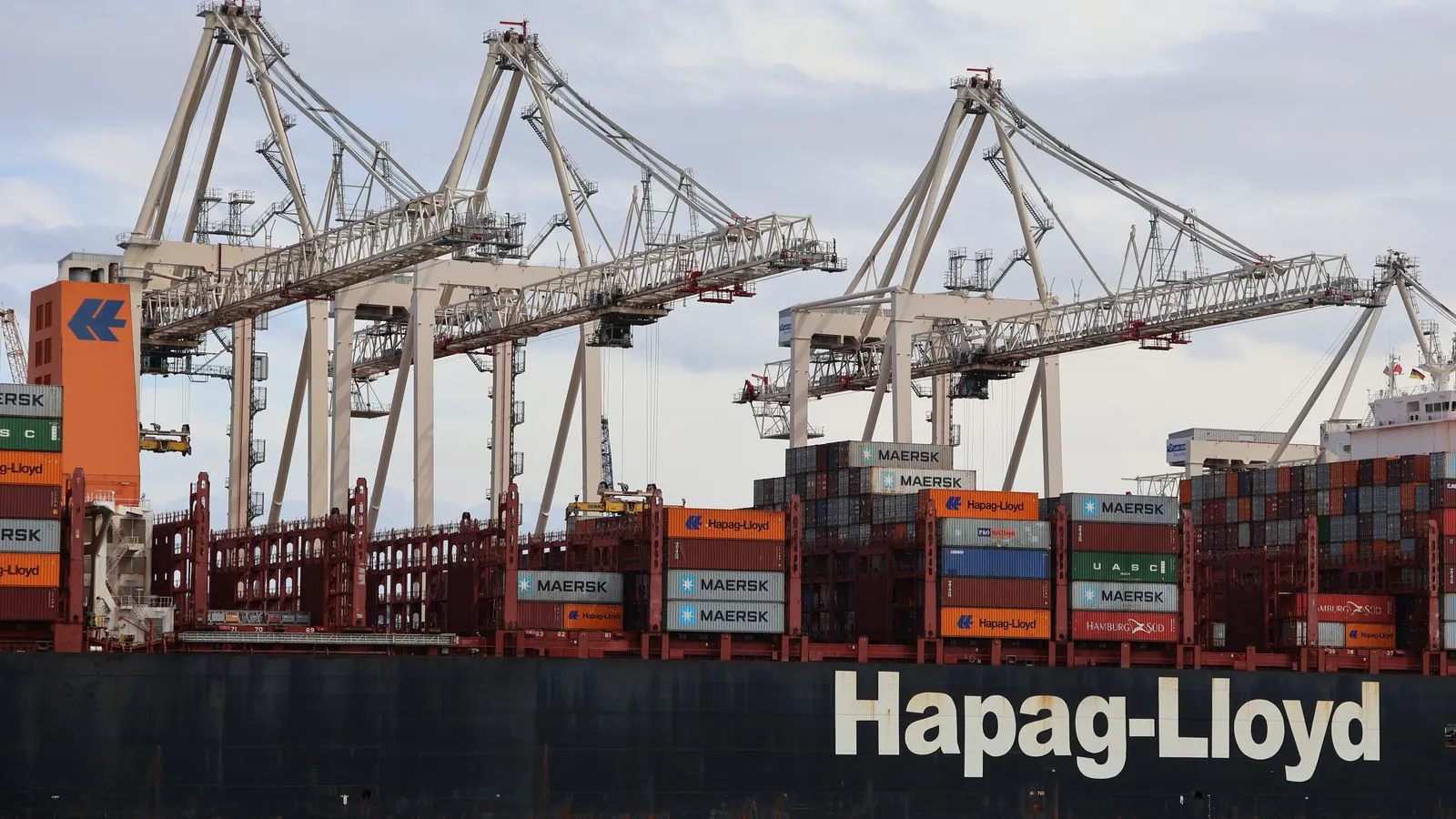 A large gantry crane structure positioned over a container yard at a port.