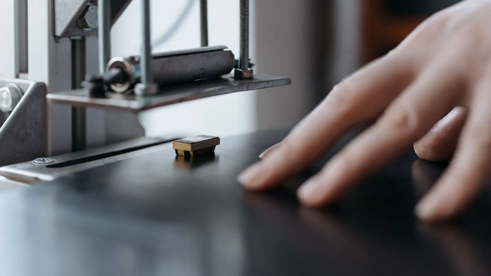 Engineer adjusting a tablet near a collaborative robot arm.