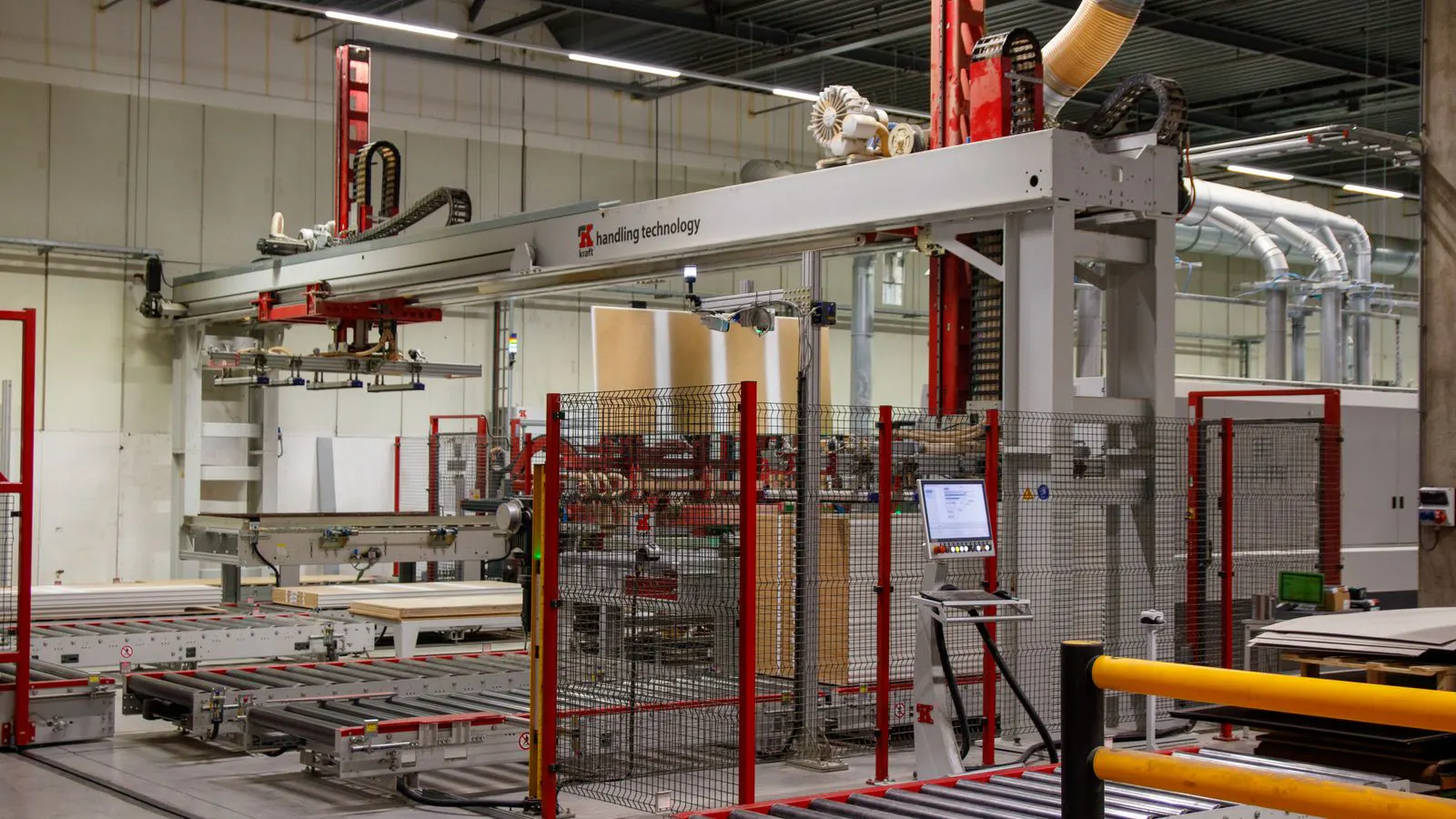 A six-axis industrial robot arm performing a pick-and-place task on an assembly line.