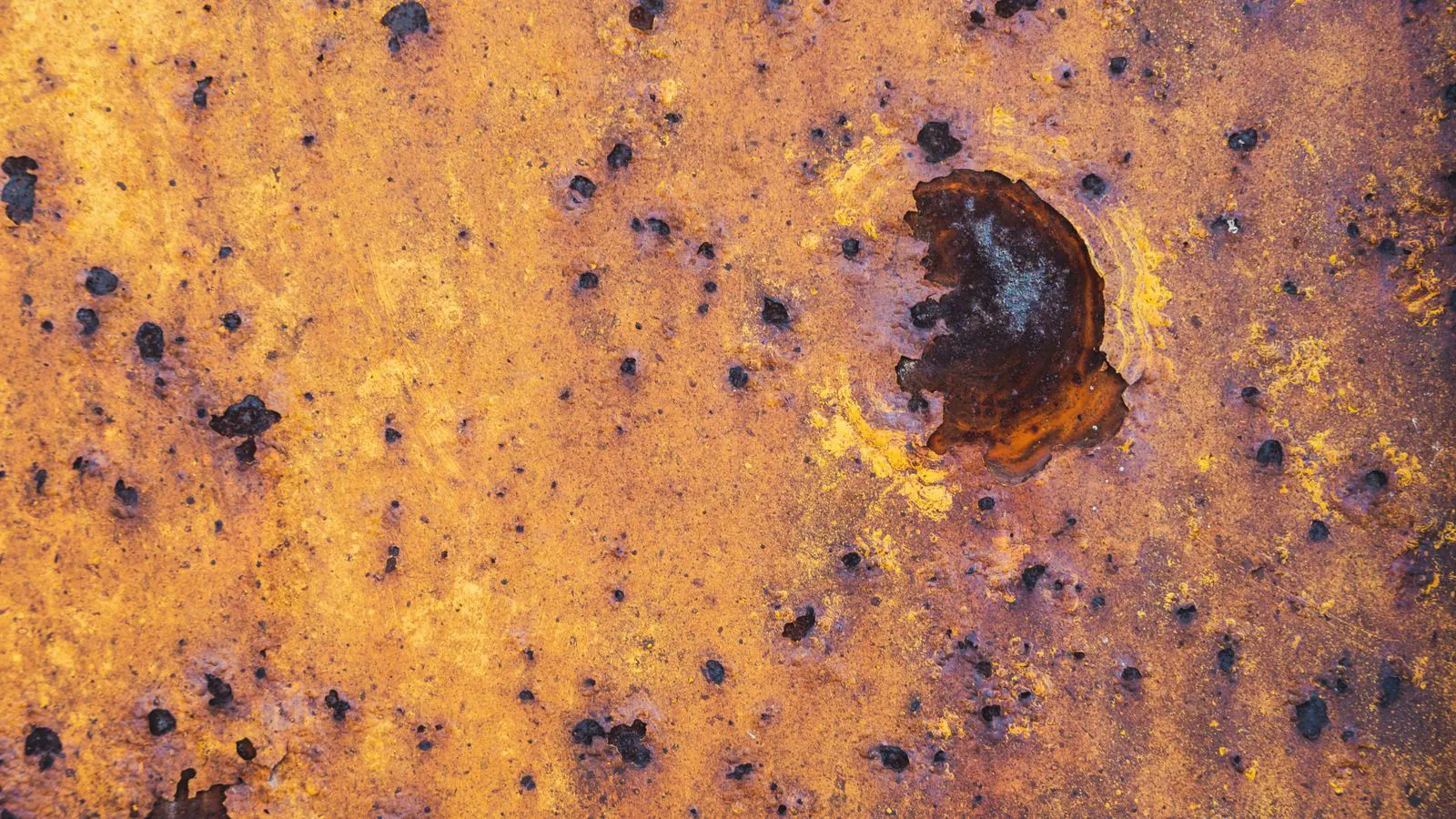 Close up of an anodized aluminum surface showing porous texture