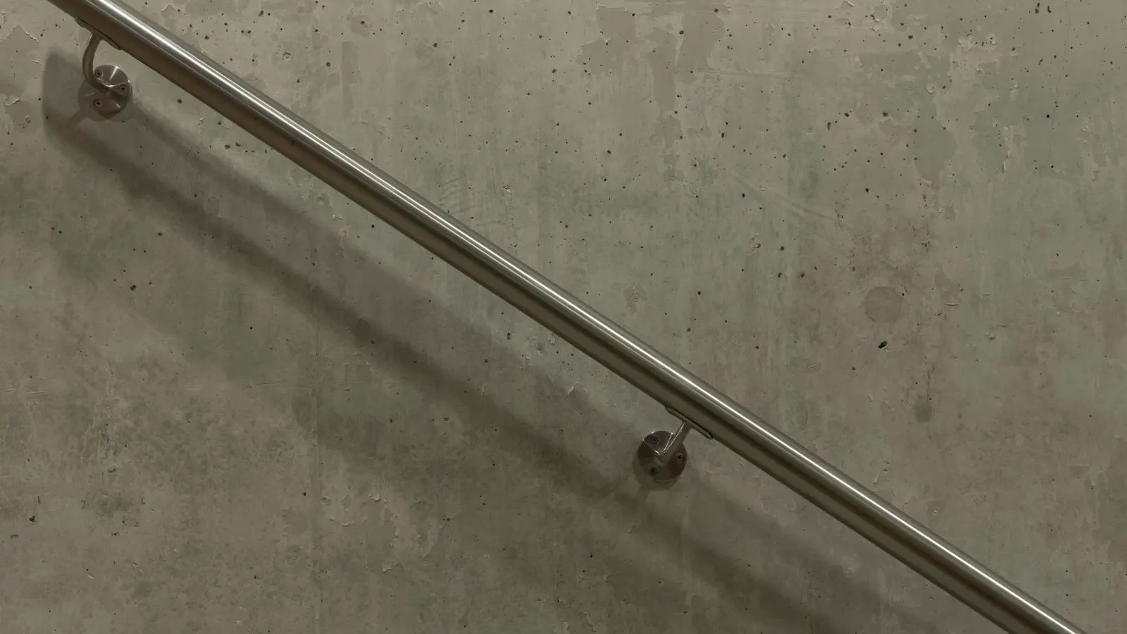 Stainless steel components suspended in a passivation solution tank.
