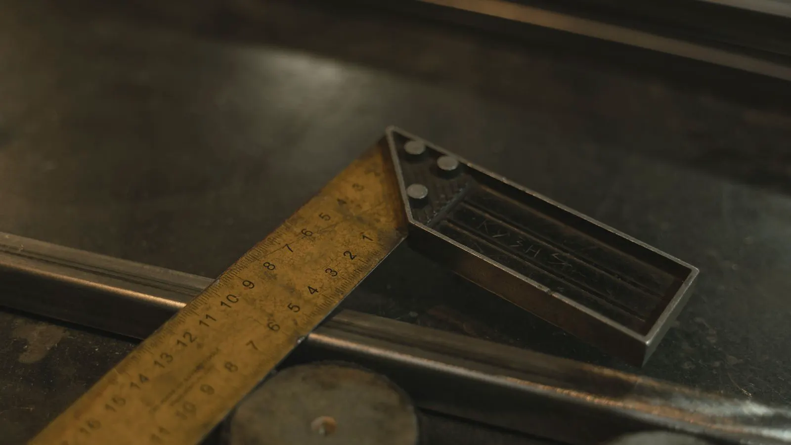 Hand holding a caliper measuring the coating on a metal surface