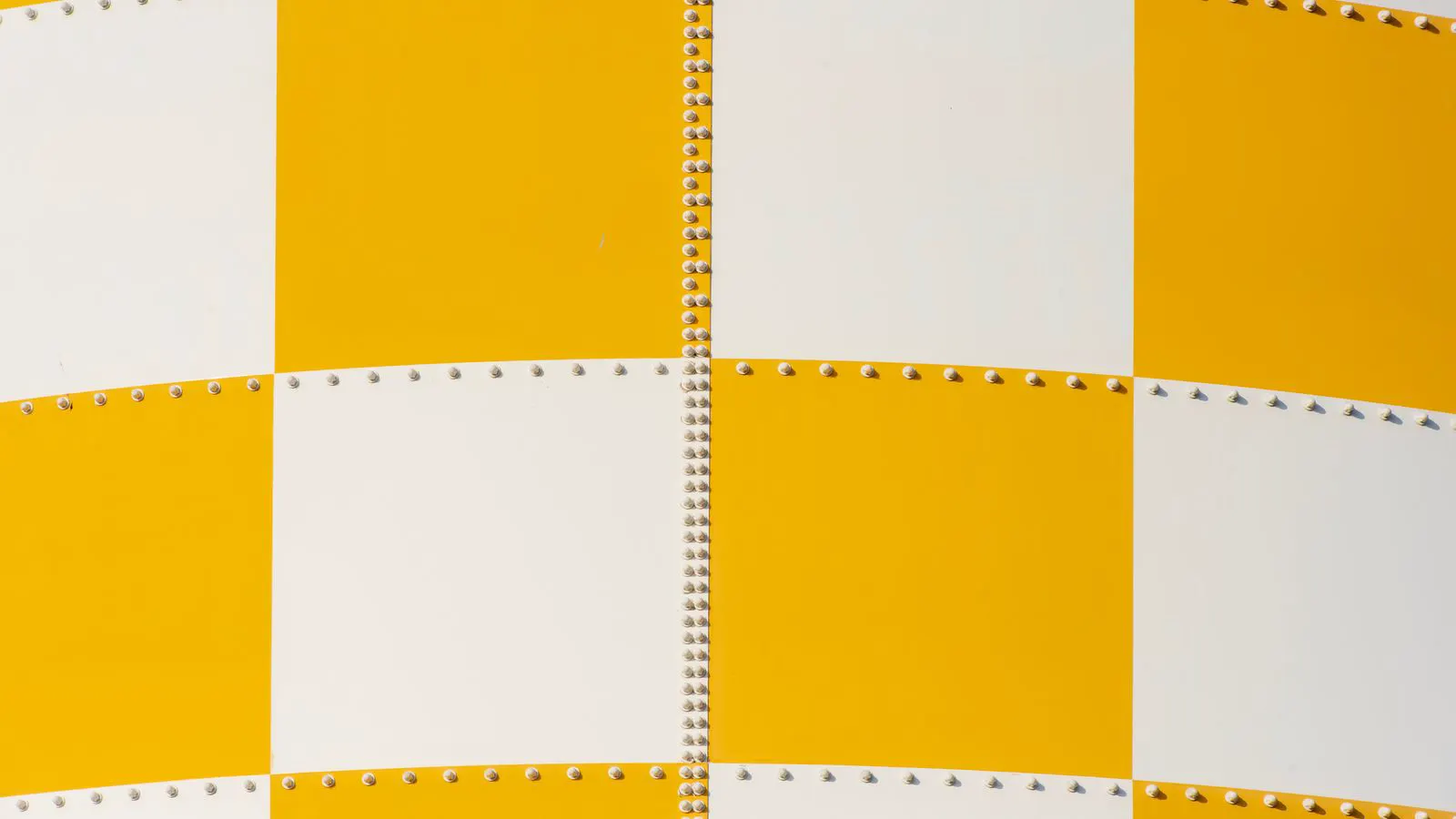 Close view of a textured metal panel with uniform orange coating