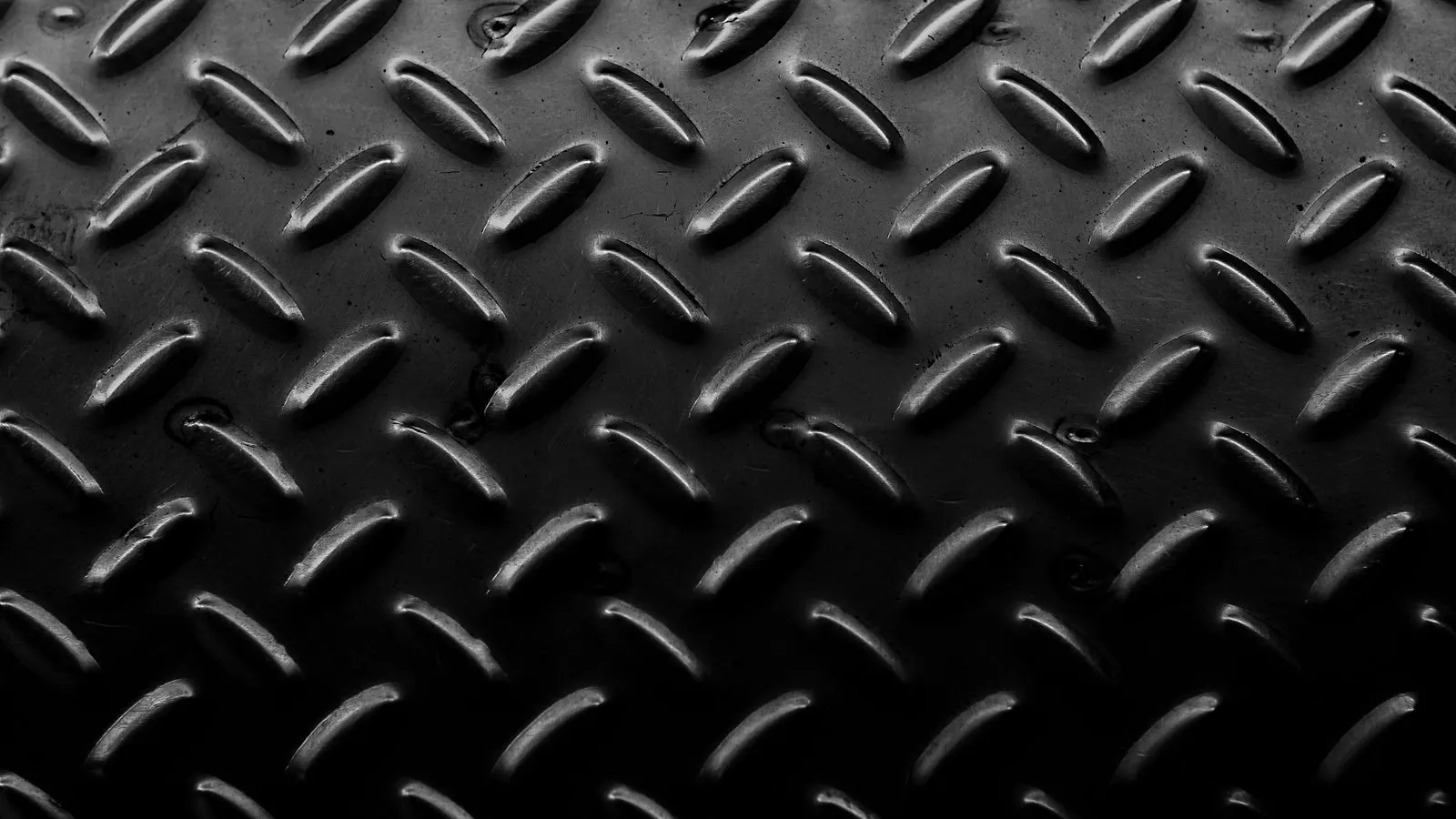Close up of a metal part showing small pinhole defects in the plating layer