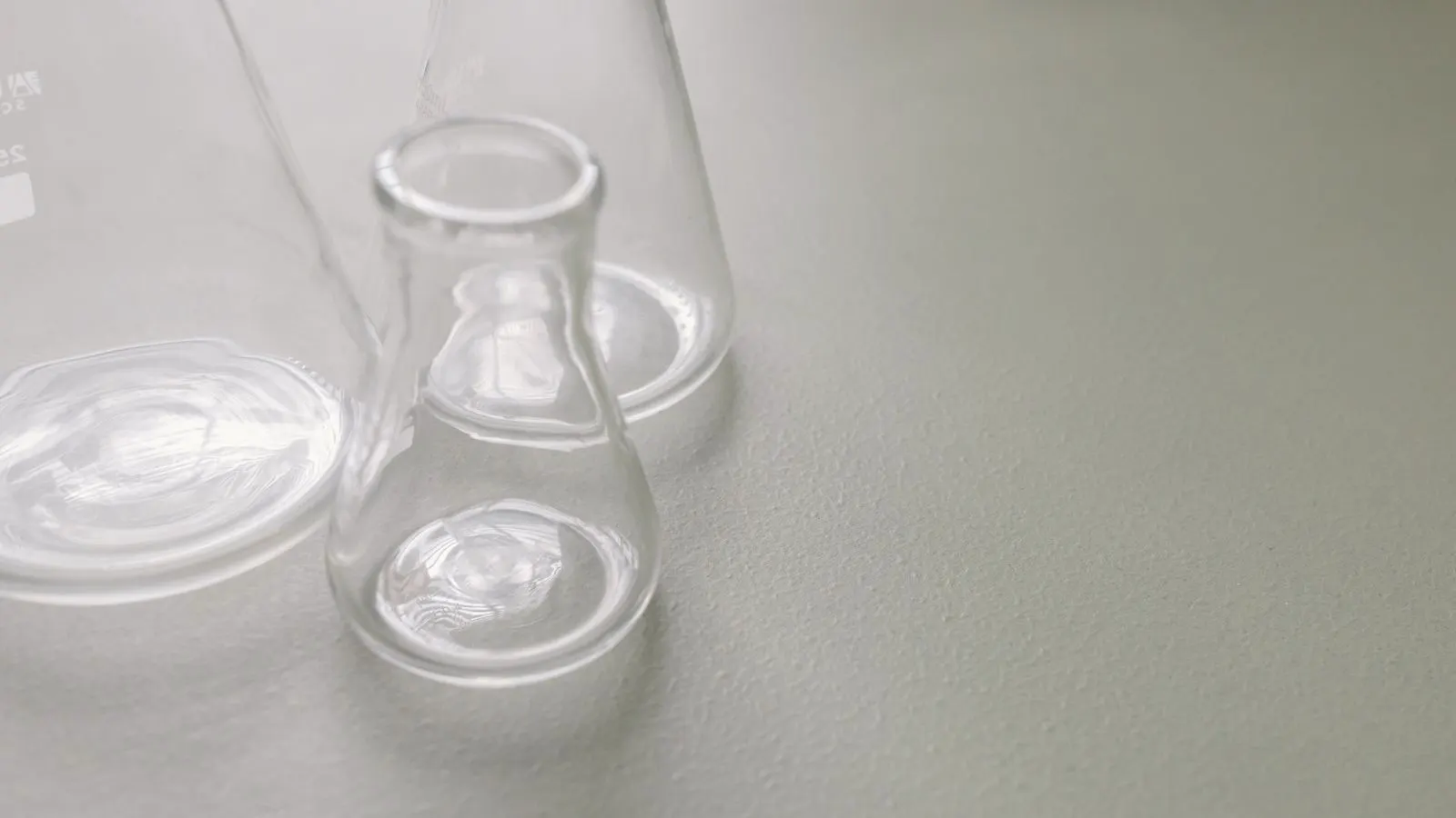 A metal part undergoing an adhesion test with a cross-hatch pattern.