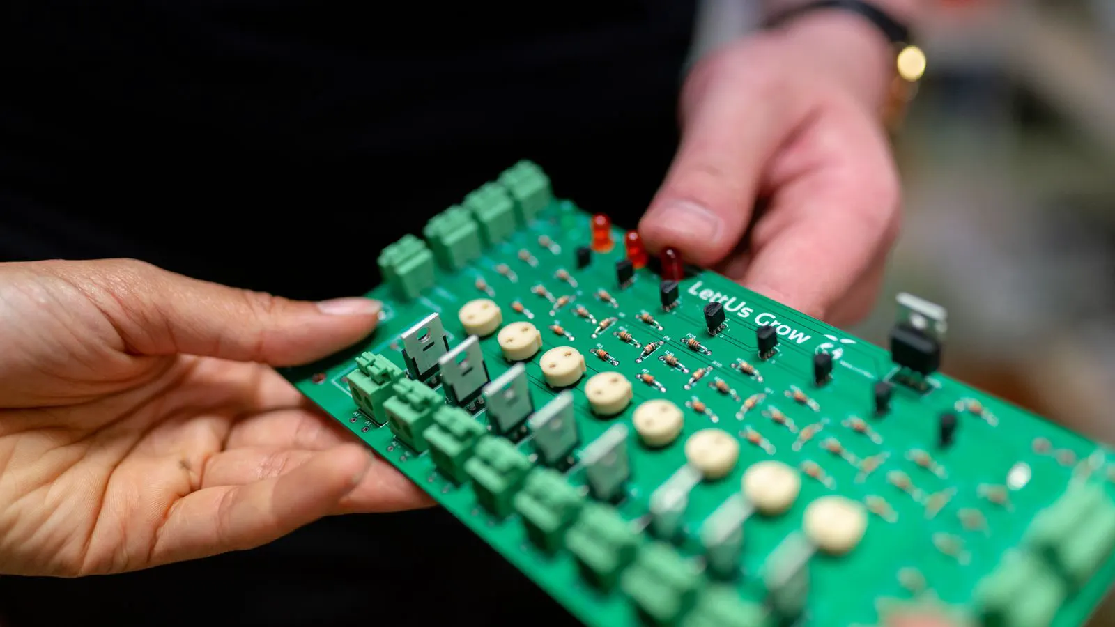A circuit board suspended in a large industrial plating tank