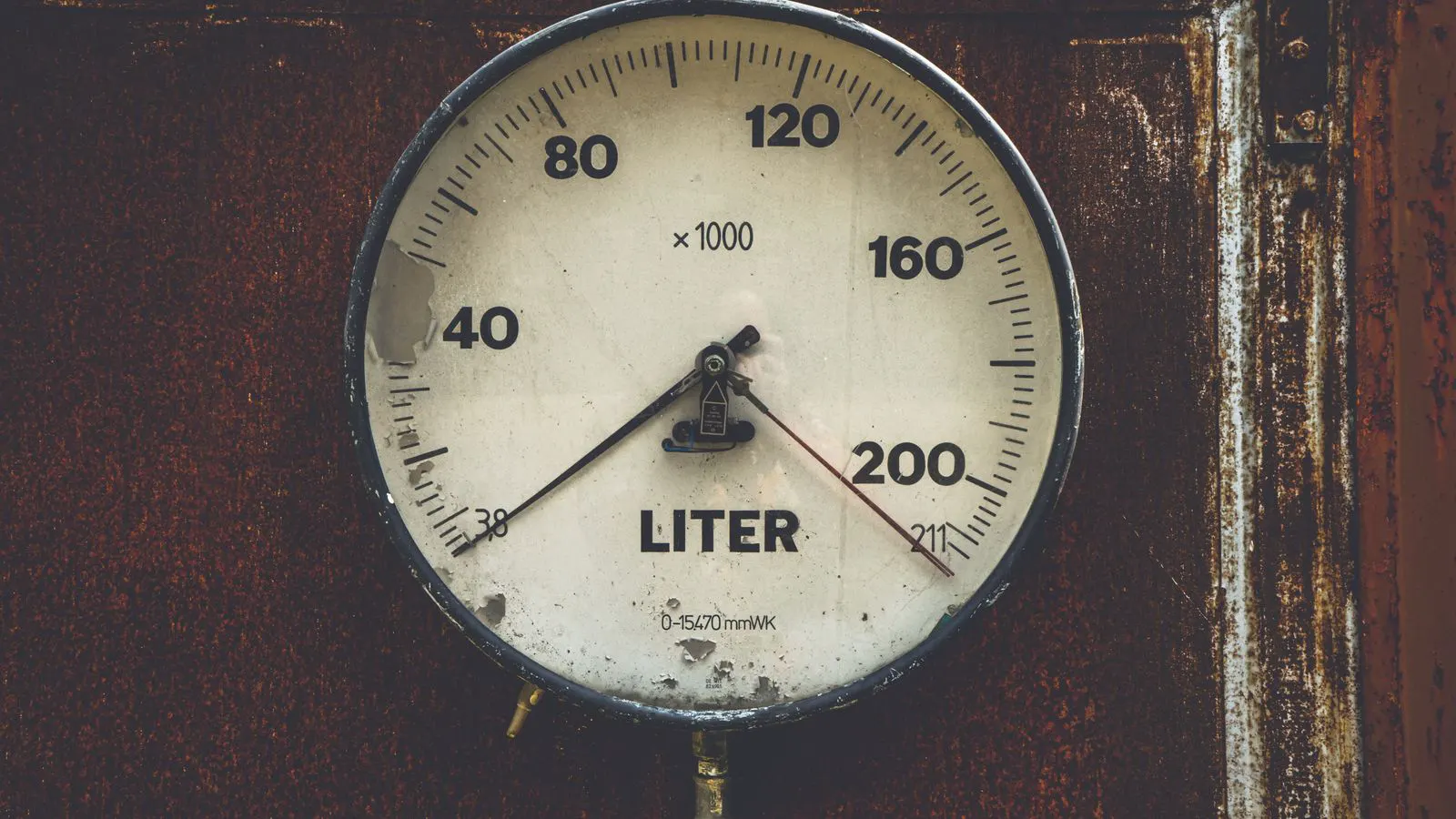 A metal part being measured with a precision thickness gauge.