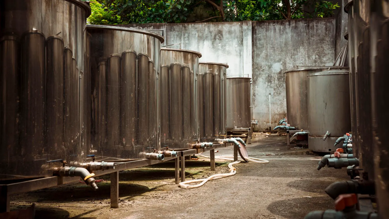 Steel parts suspended in plating tanks inside a workshop
