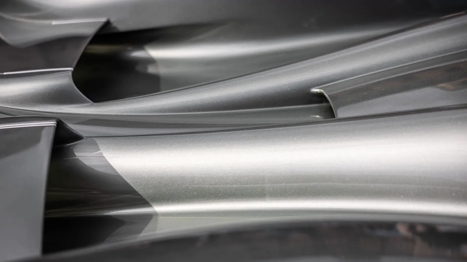A row of metal parts suspended in a plating bath.