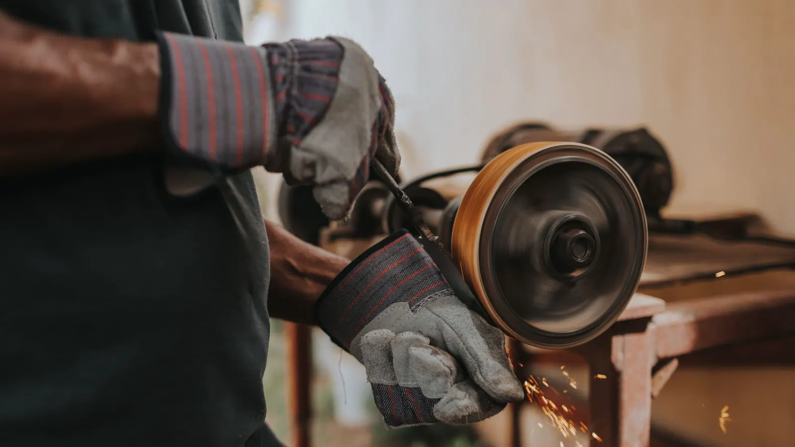 A technician using a caliper to measure a metal part surface