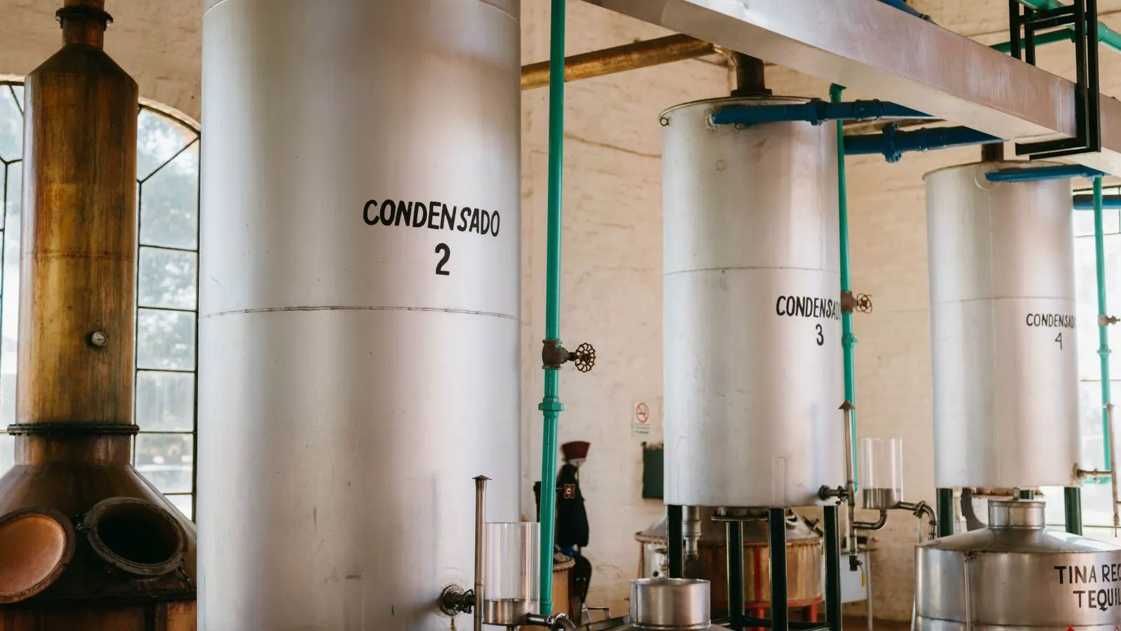 Stainless steel tanks filled with plating solution in a workshop