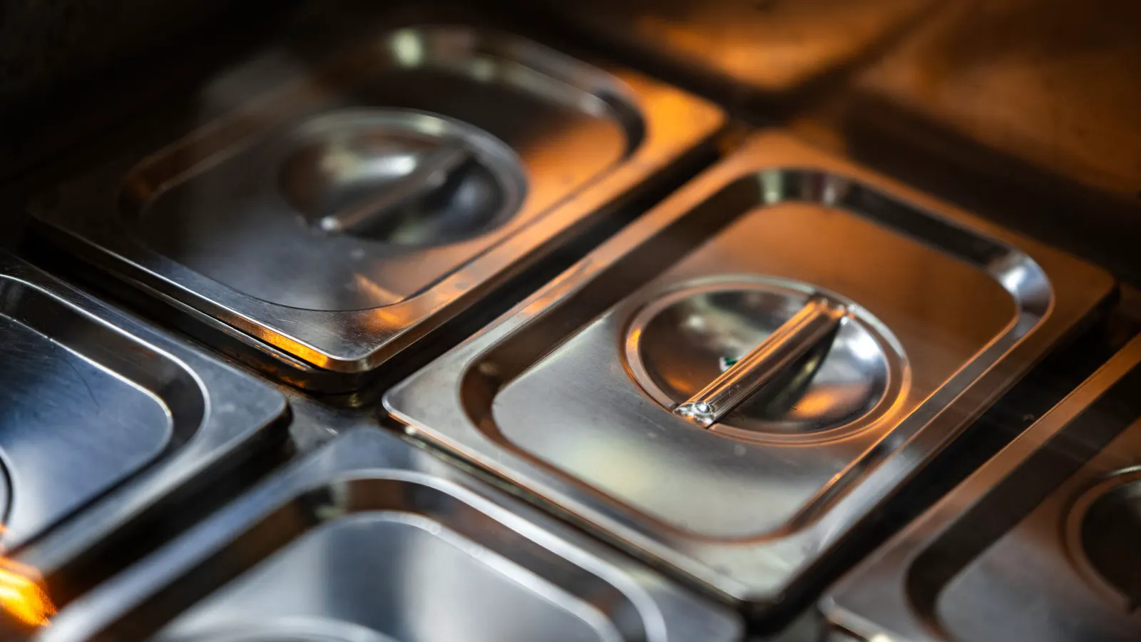 Stainless steel parts sitting in a passivation tank solution.