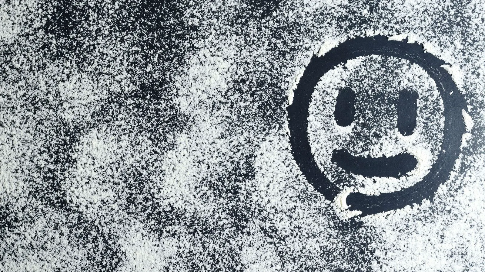 White chalking residue on a metal panel surface