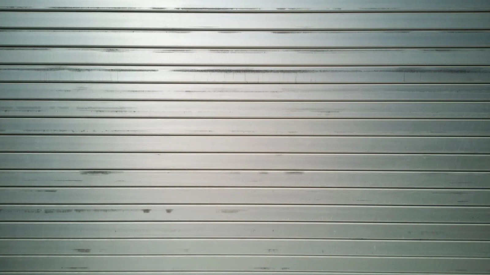 Close view of a prepared metal surface showing uneven peaks and valleys.