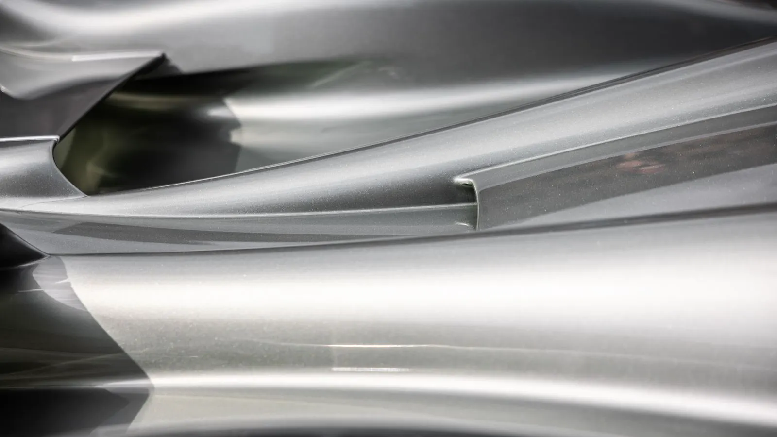 Close up of a metal part coated in red powder finish